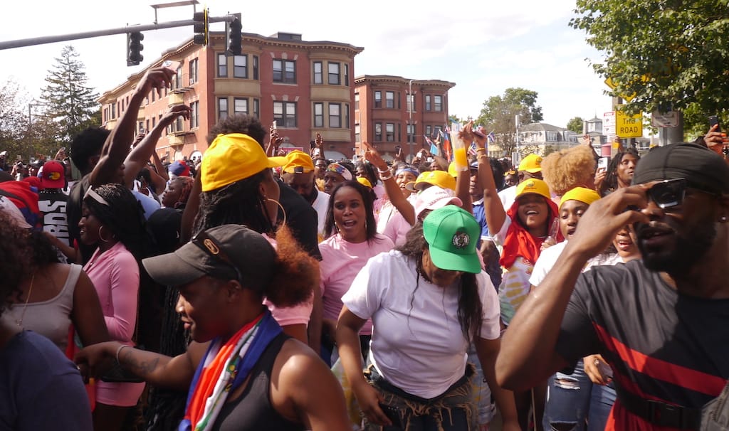 Hundreds of people dance on Warren Street during Caribbean Carnival.