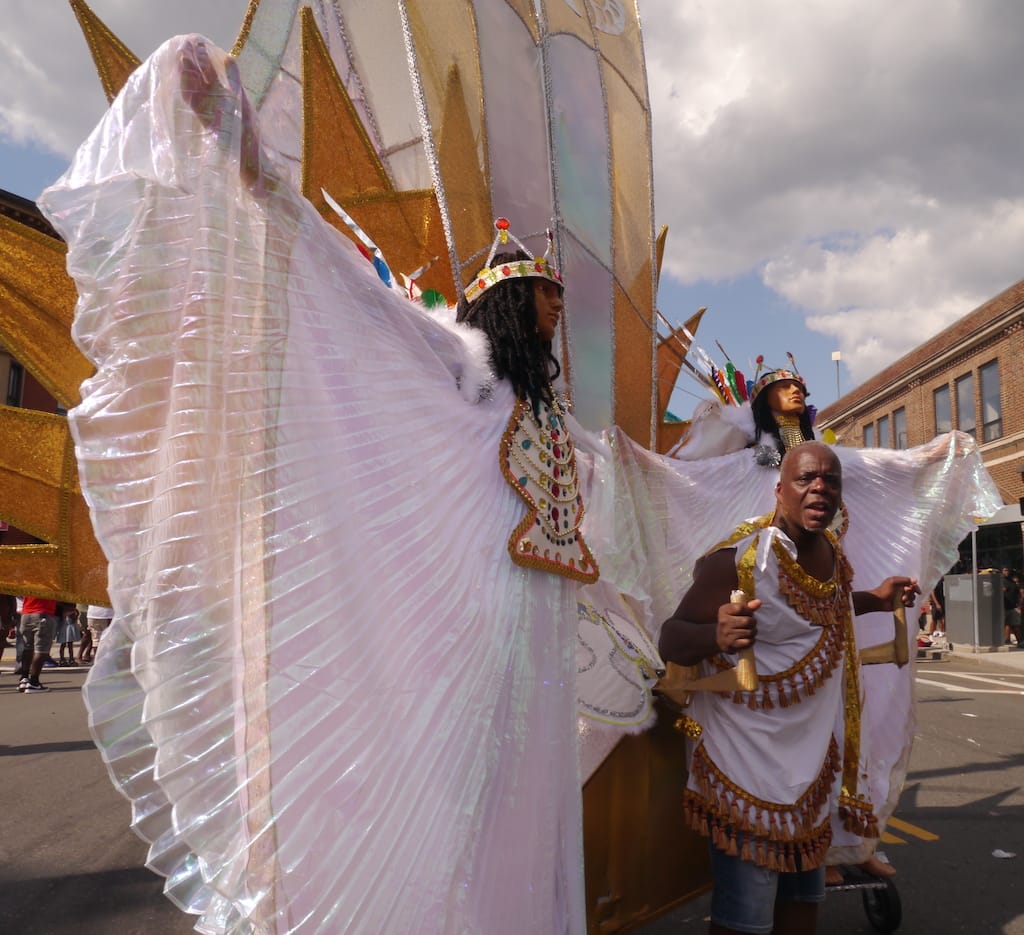 Ken Douglas, band leader of Suave, poses with a large white and gold costume.