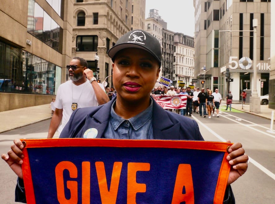 U.S. Rep. Ayanna Pressley marches in Boston's Labor Day parade. 