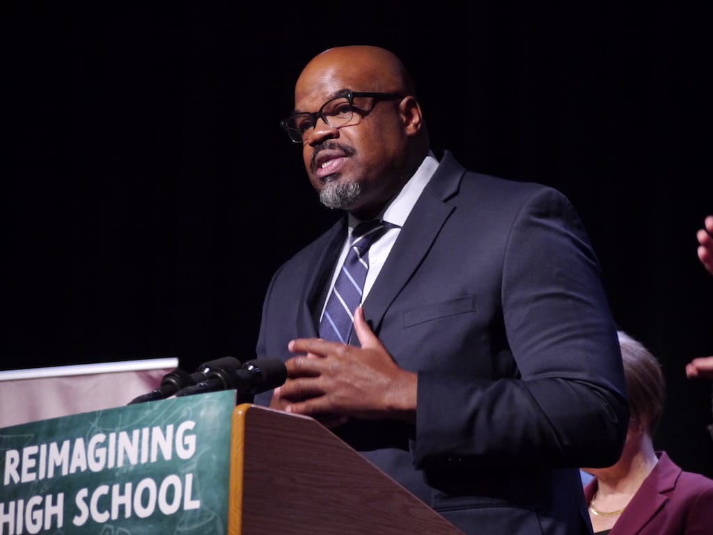 Education Secretary Patrick Tutwiler speaks at the podium at Dedham High School.