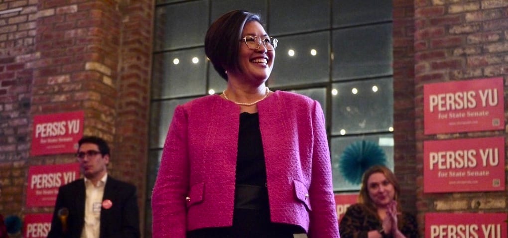 Student loan borrower advocate Persis Yu greets supporters at the Roundhead Brewing company taproom in Hyde Park as supporters applaud.