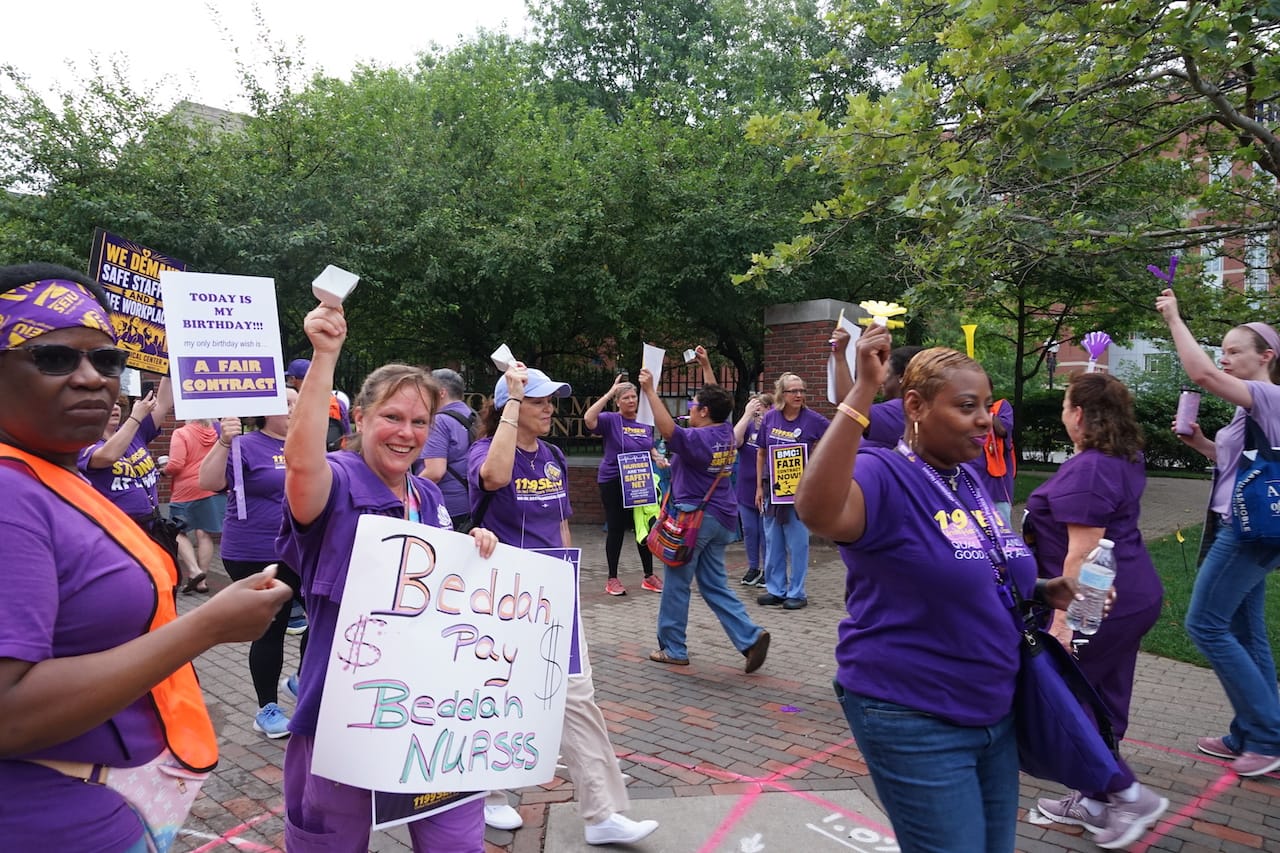 Nurses wearing purple SEIU t-shirts and carrying signs picket at the Harrison Avenue entrance to Boston Medical Center on July 22. Yawu Miller photo