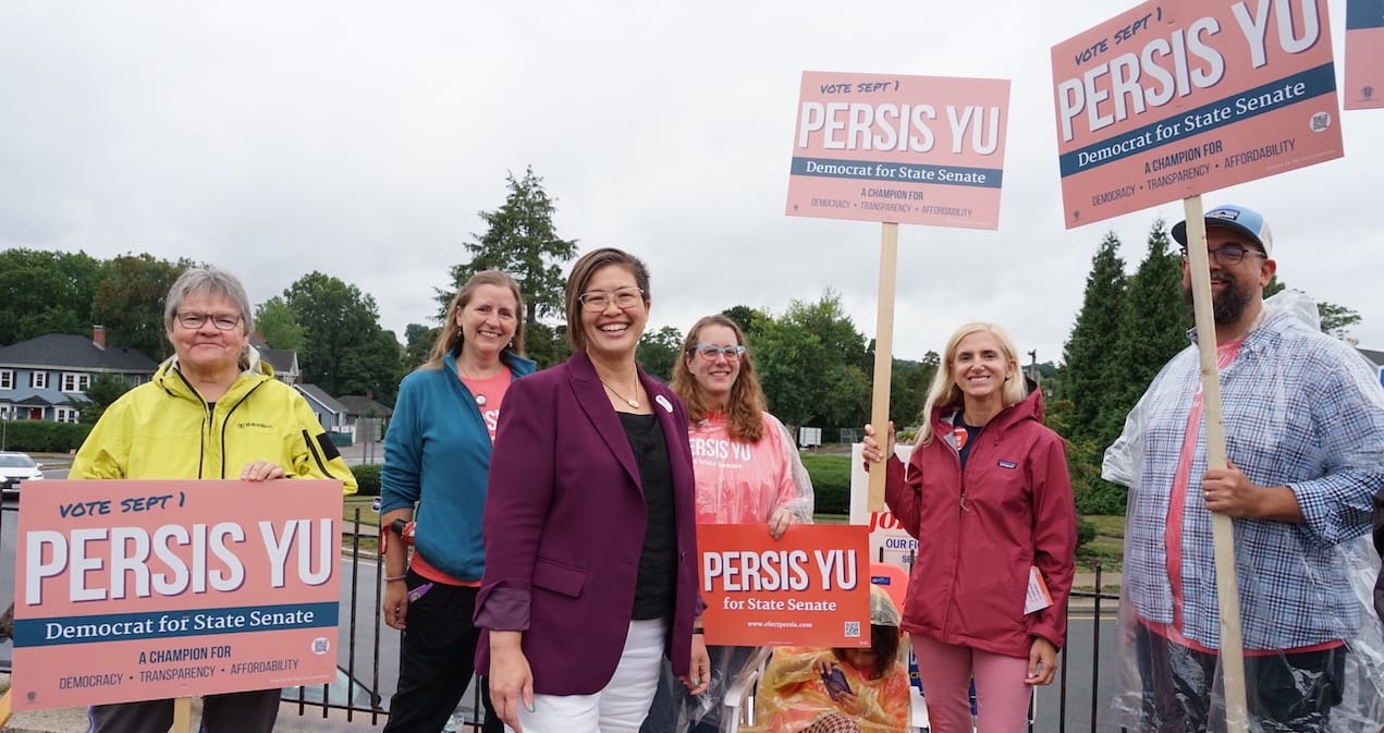 Attorney and consumer advocate Persis Yu stands with supporters outside the Holy Name Parish polling location in West Roxbury. Yu defeated incumbent Sen. Michael Rush in the Tuesday primary.