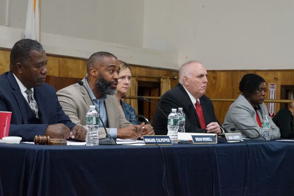 District 4 Councilor Brian Worrell, seated at a head table, speaks. Next to him, from left to right, are councilors Miniard Culpepper, Erin Murphy, Ed Flynn and Ruthzee Louijeune.