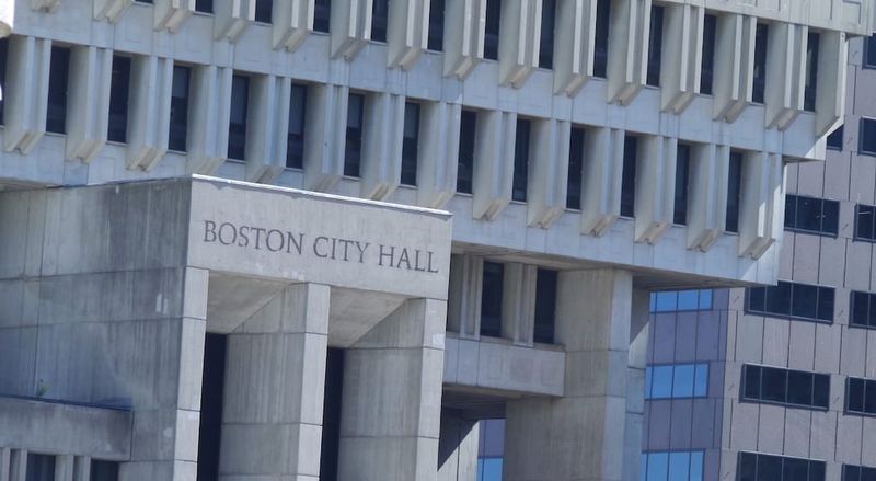 Image is a closeup of the exterior of Boston City Hall.