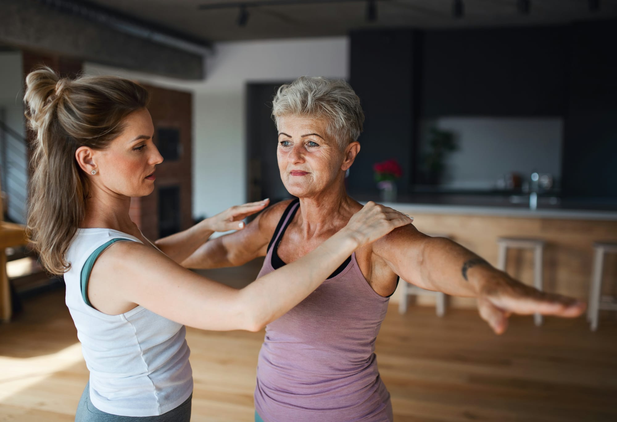 Physiotherapist ist guiding posture of a patient.