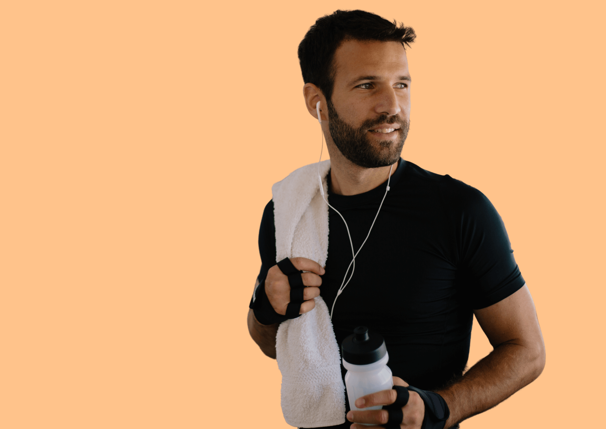 Man with bottle of water, towel and headphones in gym.