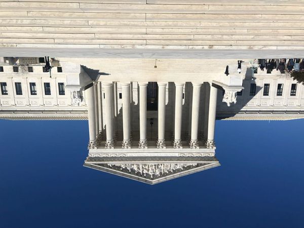 The Supreme Court building in Washington DC, but flipped upside down. Photo credit Marielam1 