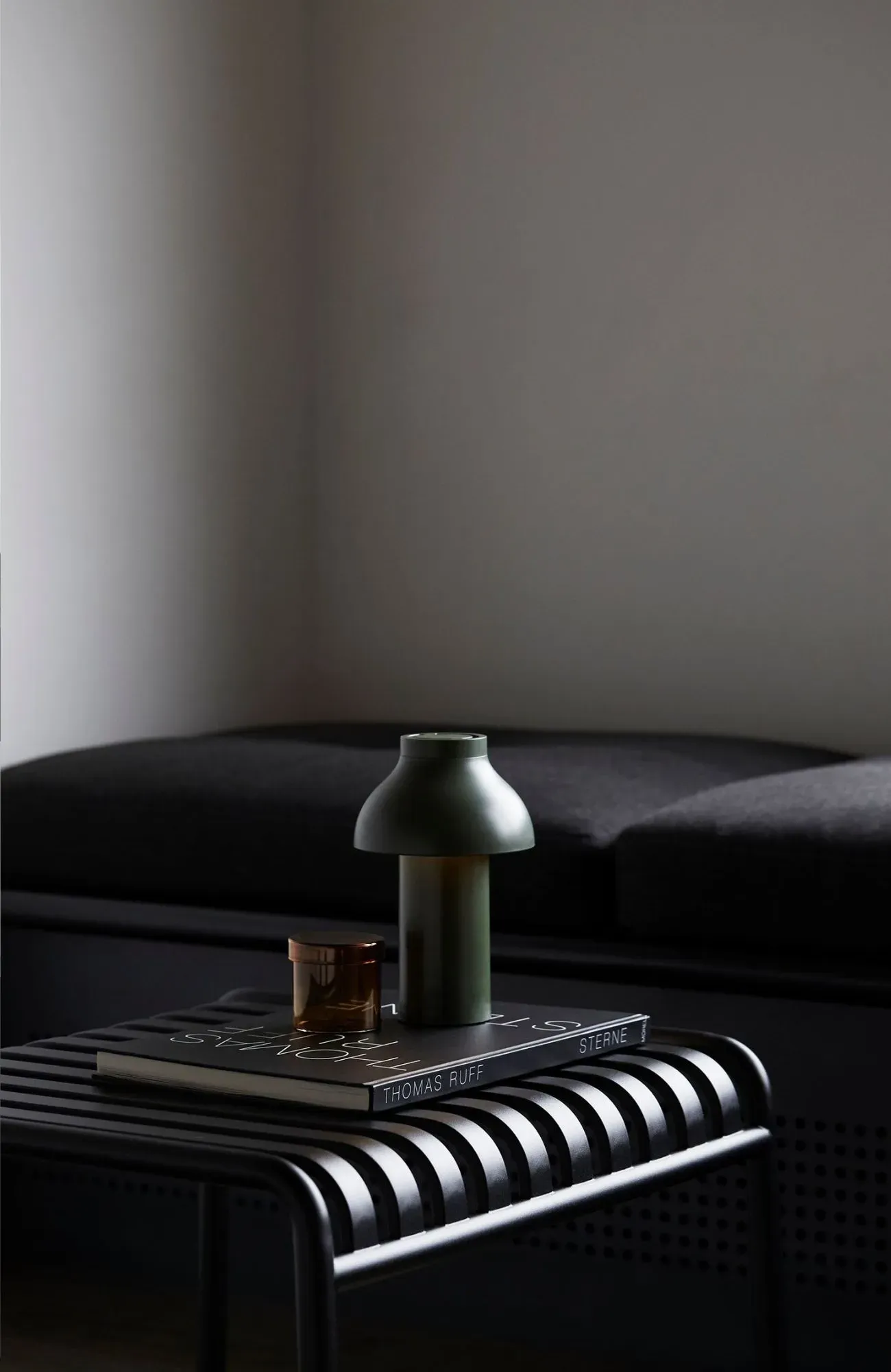 Cedar Cabin by Nicholas Gurney & Monique Easton. Styled coffee table book on black stool.