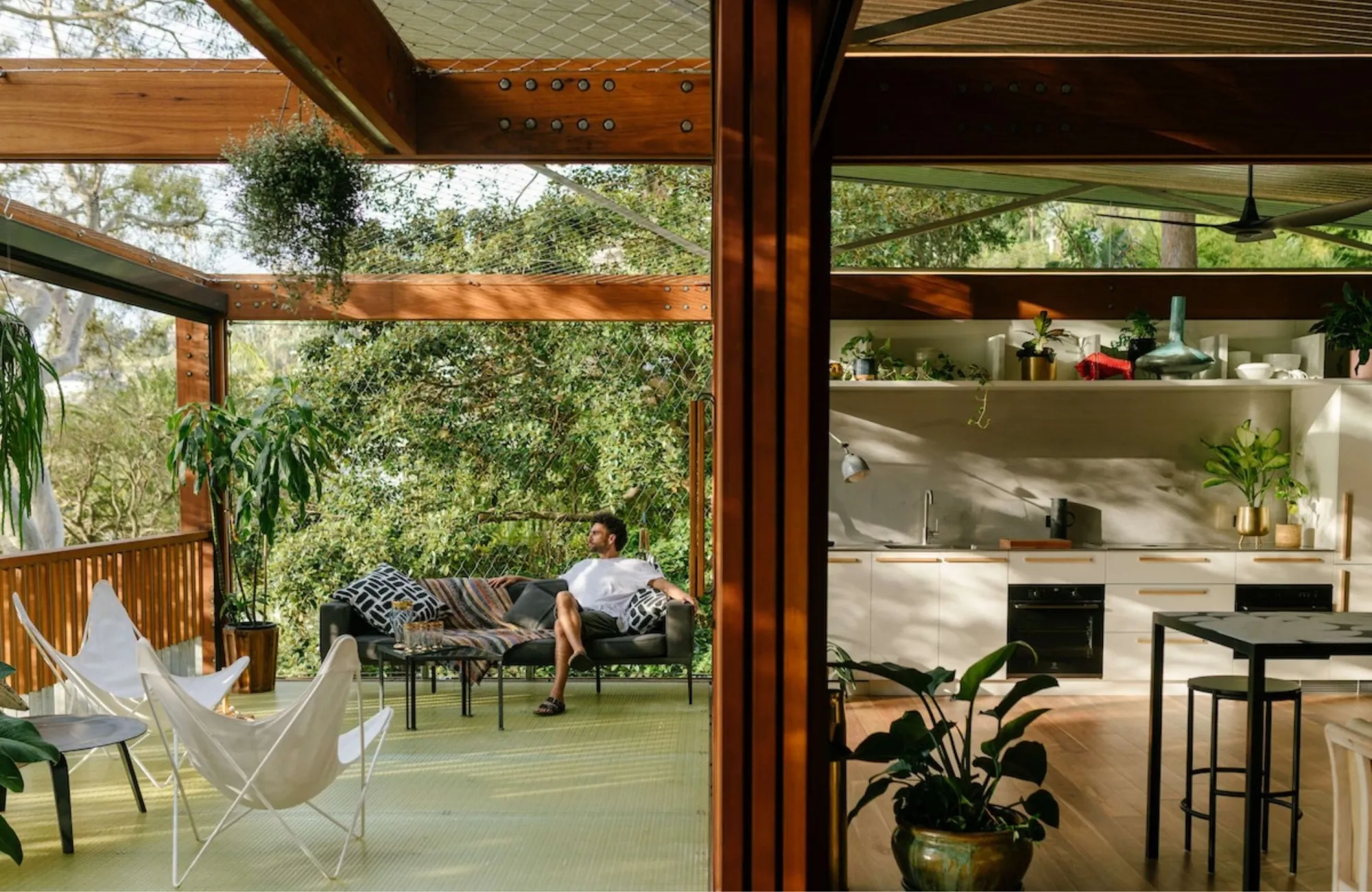 Balmy Palmy by CplusC Architectural Workshop. Outdoor decking area with a picturesque view of the surrounding nature (left) Indoor kitchen (right)