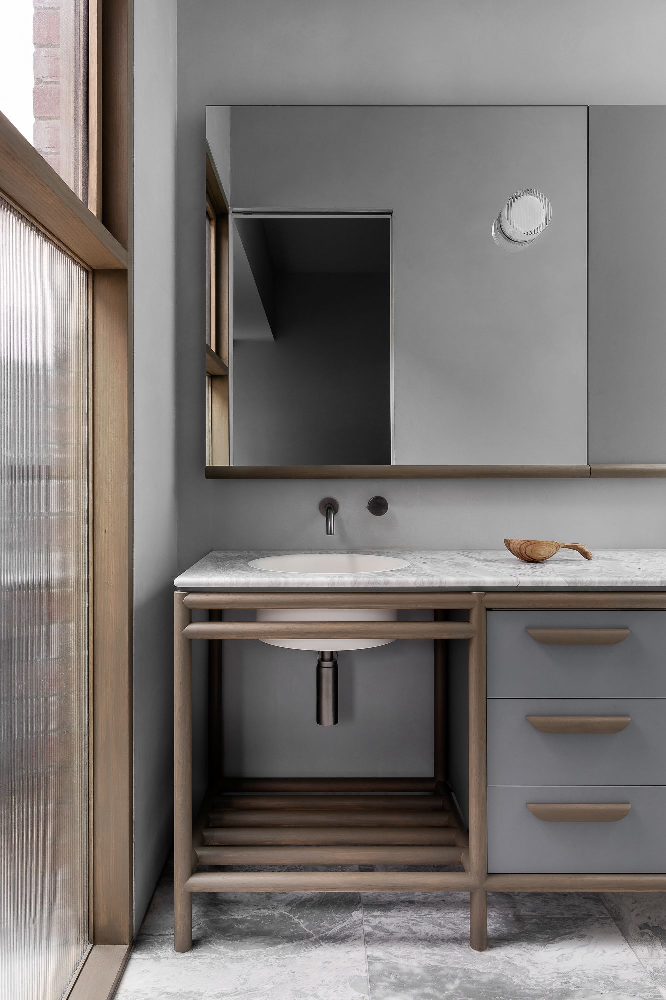 Ripponlea House by Luke Fry Architecture and Interior Design. Bathroom vanity featuring European oak, natural stone, concrete material palette 