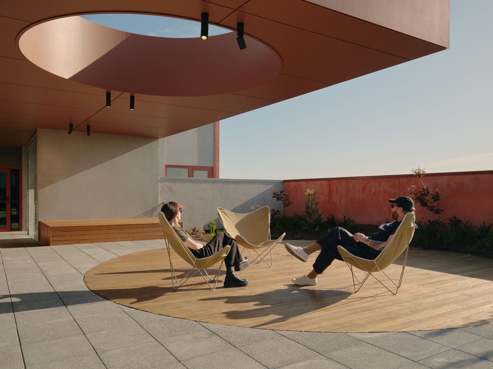 Nightingale Leftfield By Kennedy Nolan. Outdoor courtyard, two residences sitting outside. 