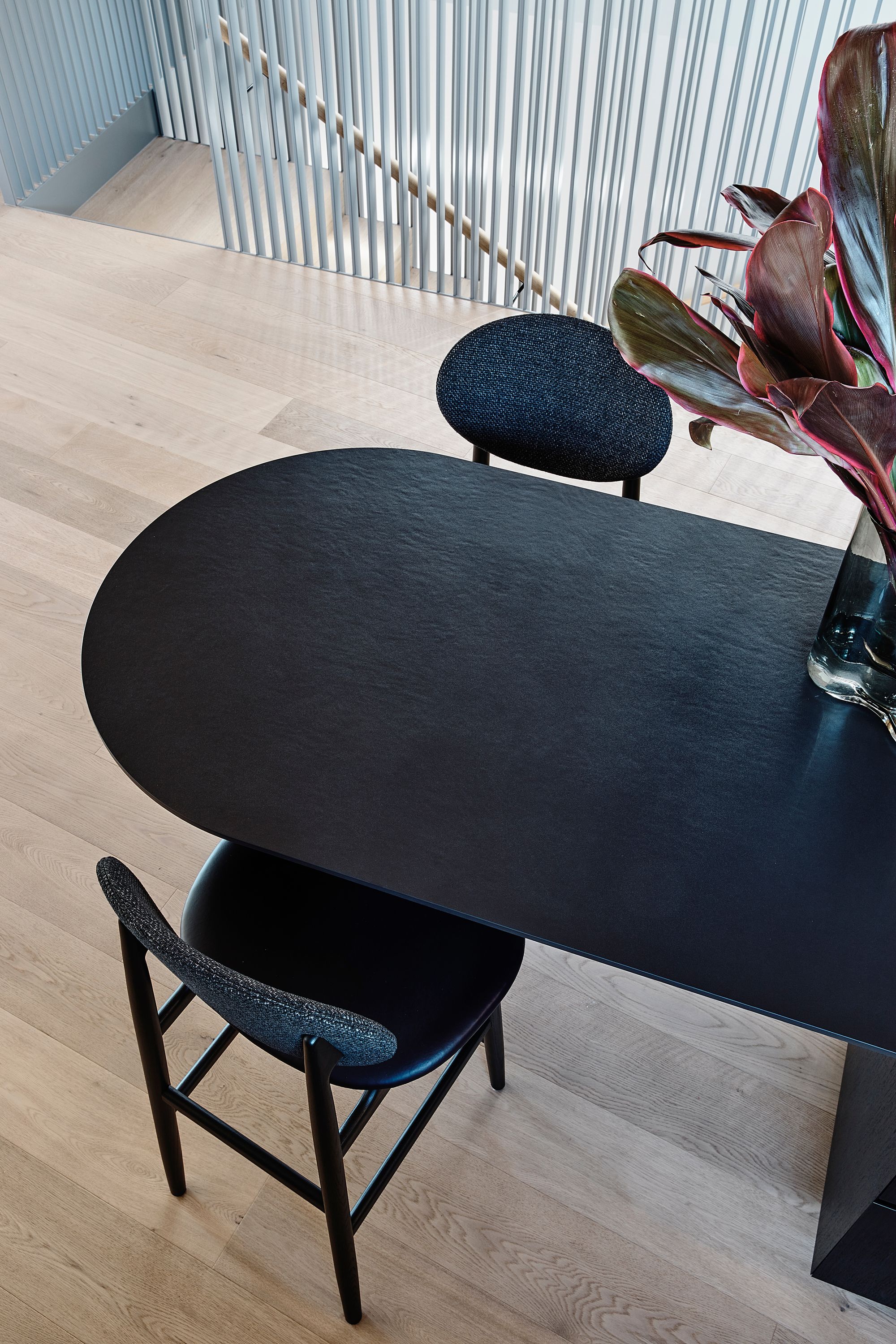 Brimar House by Michael Ong Design Office.  Birds eye view of Dining room, featuring staircase leading to guest level. . 