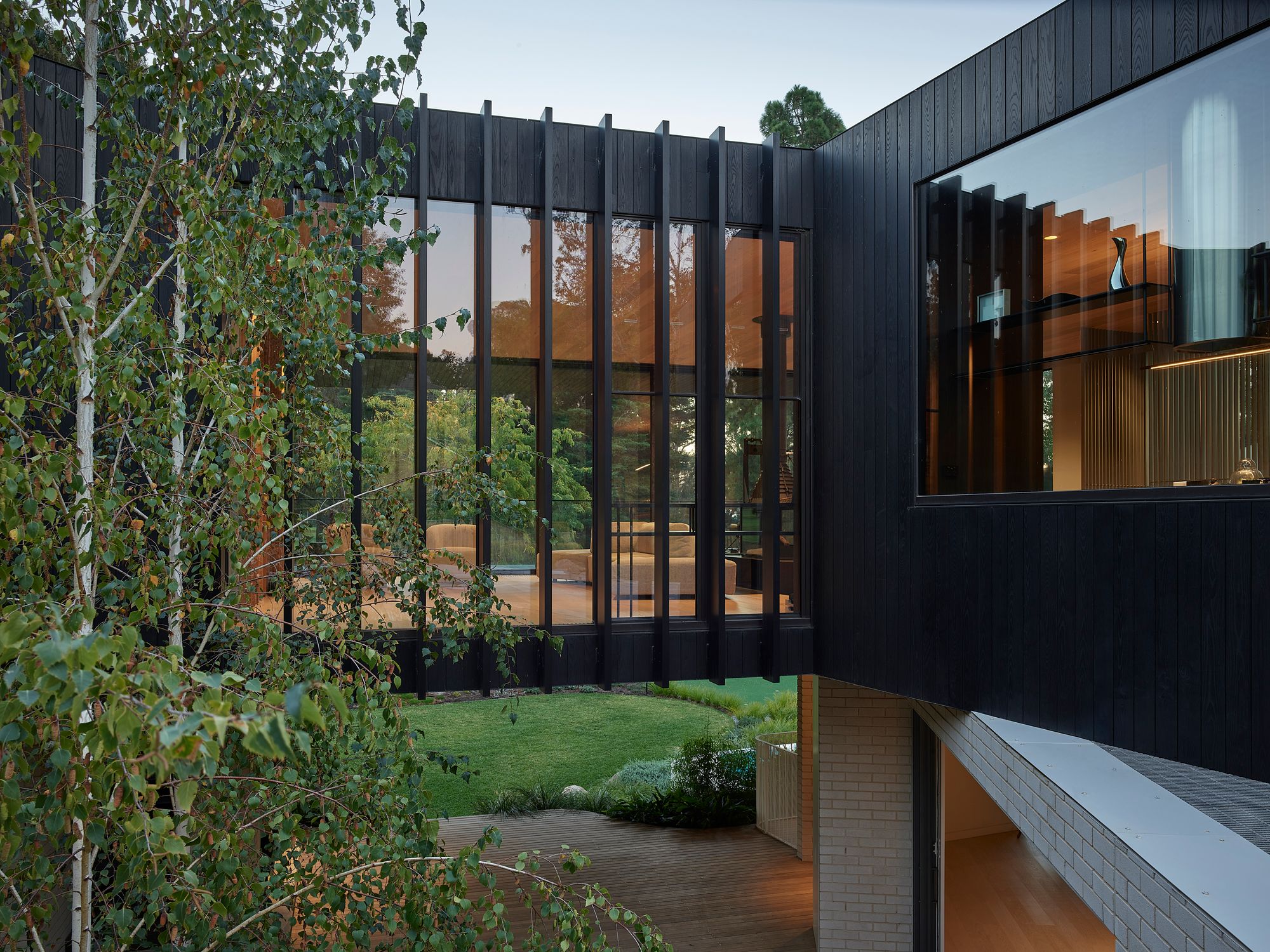 Brimar House by Michael Ong Design Office. View of exterior from 2nd level.  Showing the contrast in materiality from base to second level. 