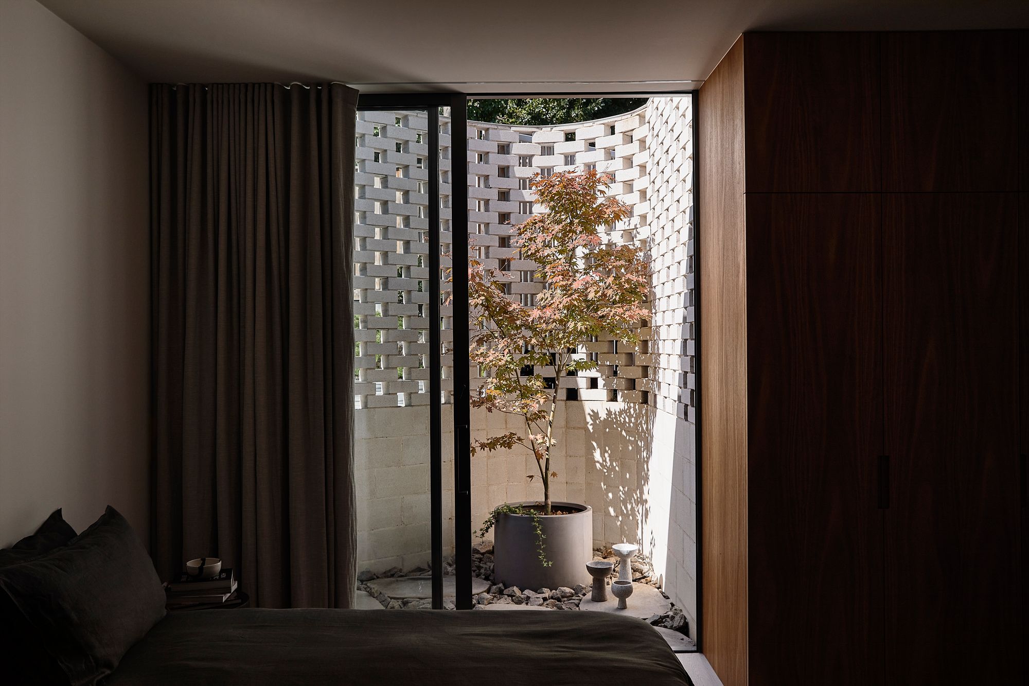 Brimar House by Michael Ong Design Office. Bedroom opening up to small courtyard. 