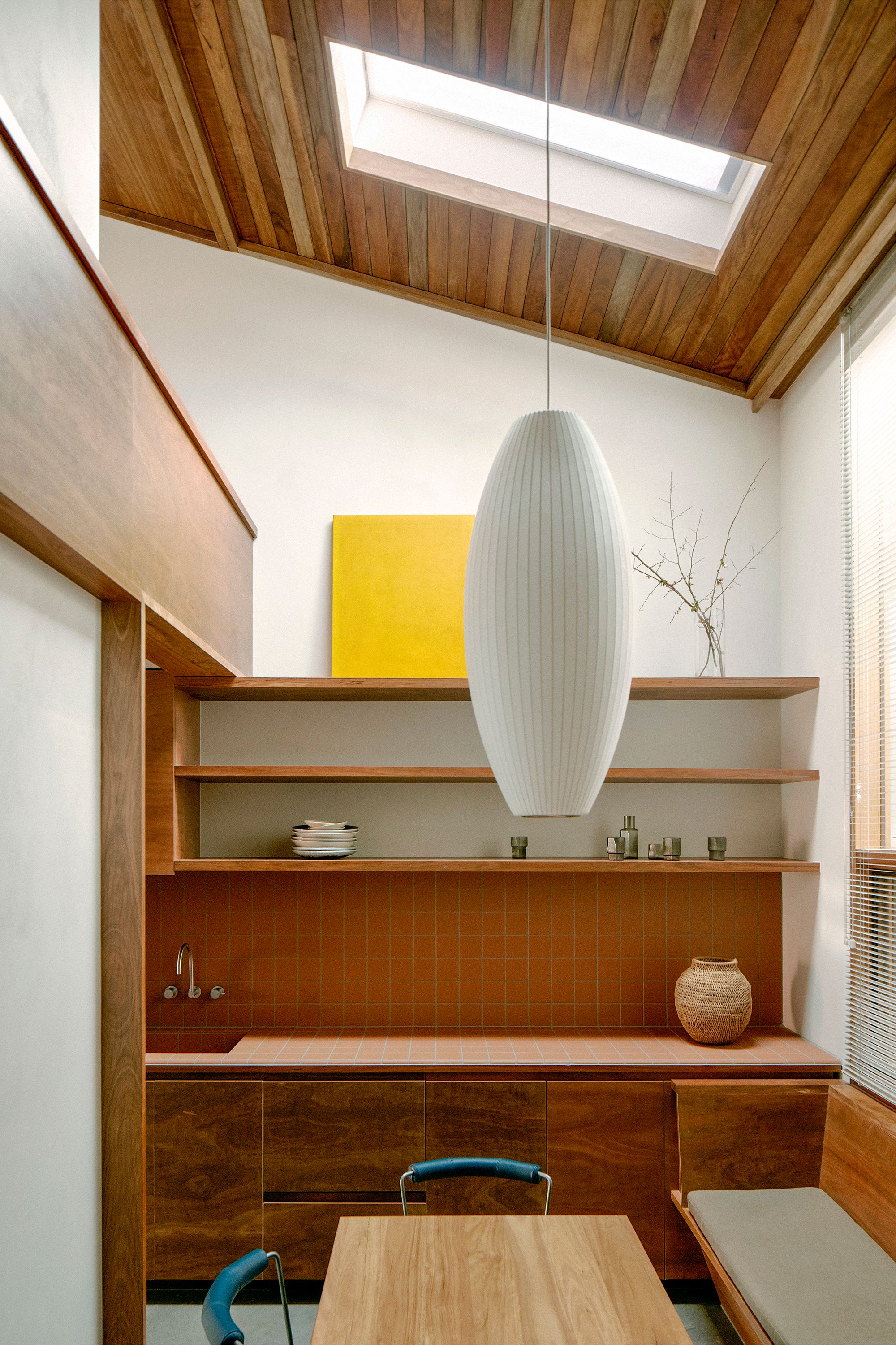Brunswick by Placement Studio showing interior view of tiled kitchen and pendant light over dining nook
