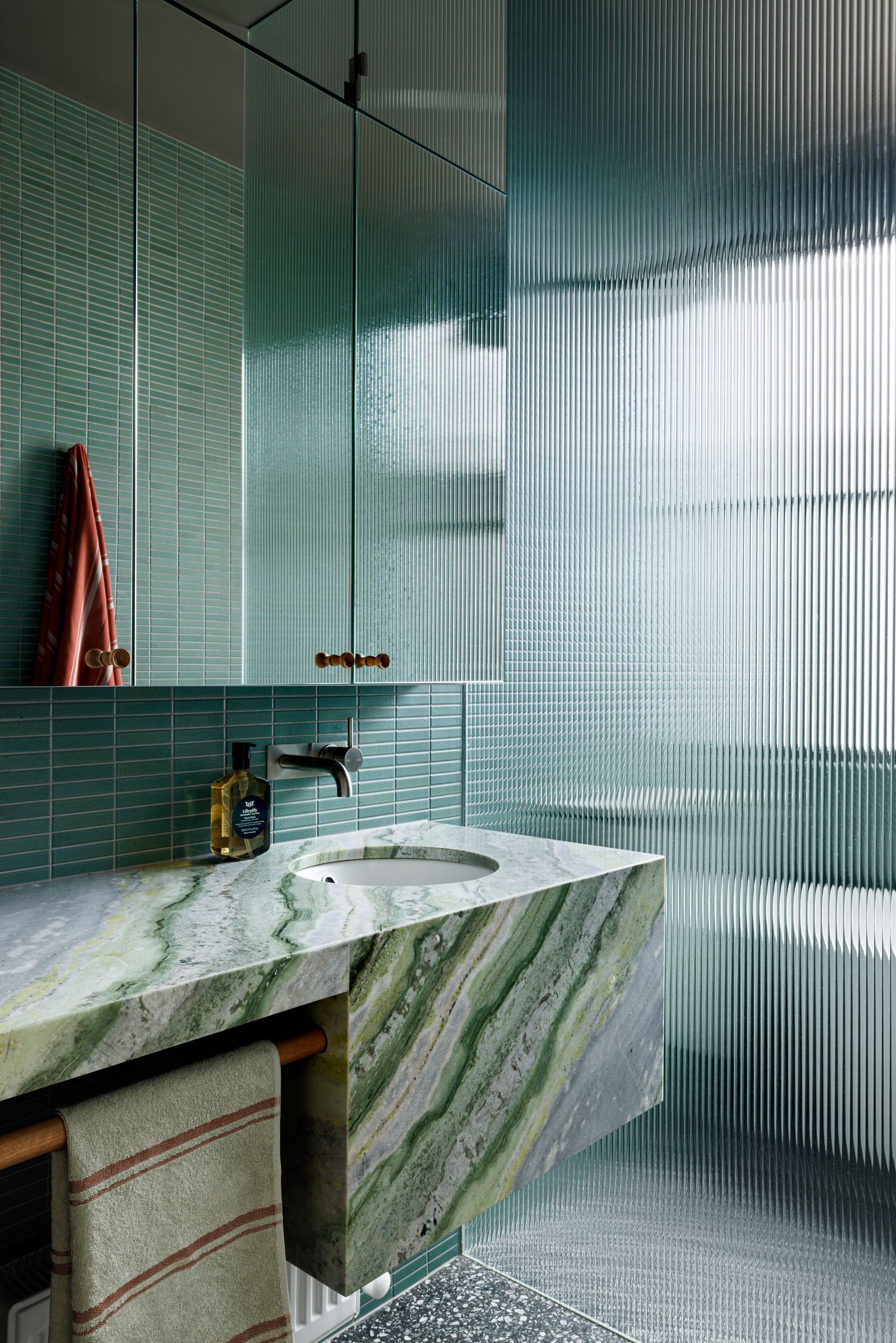 Tiara House by FMD Architects. Bathroom, featuring chartreuse and green veined stone finishes 