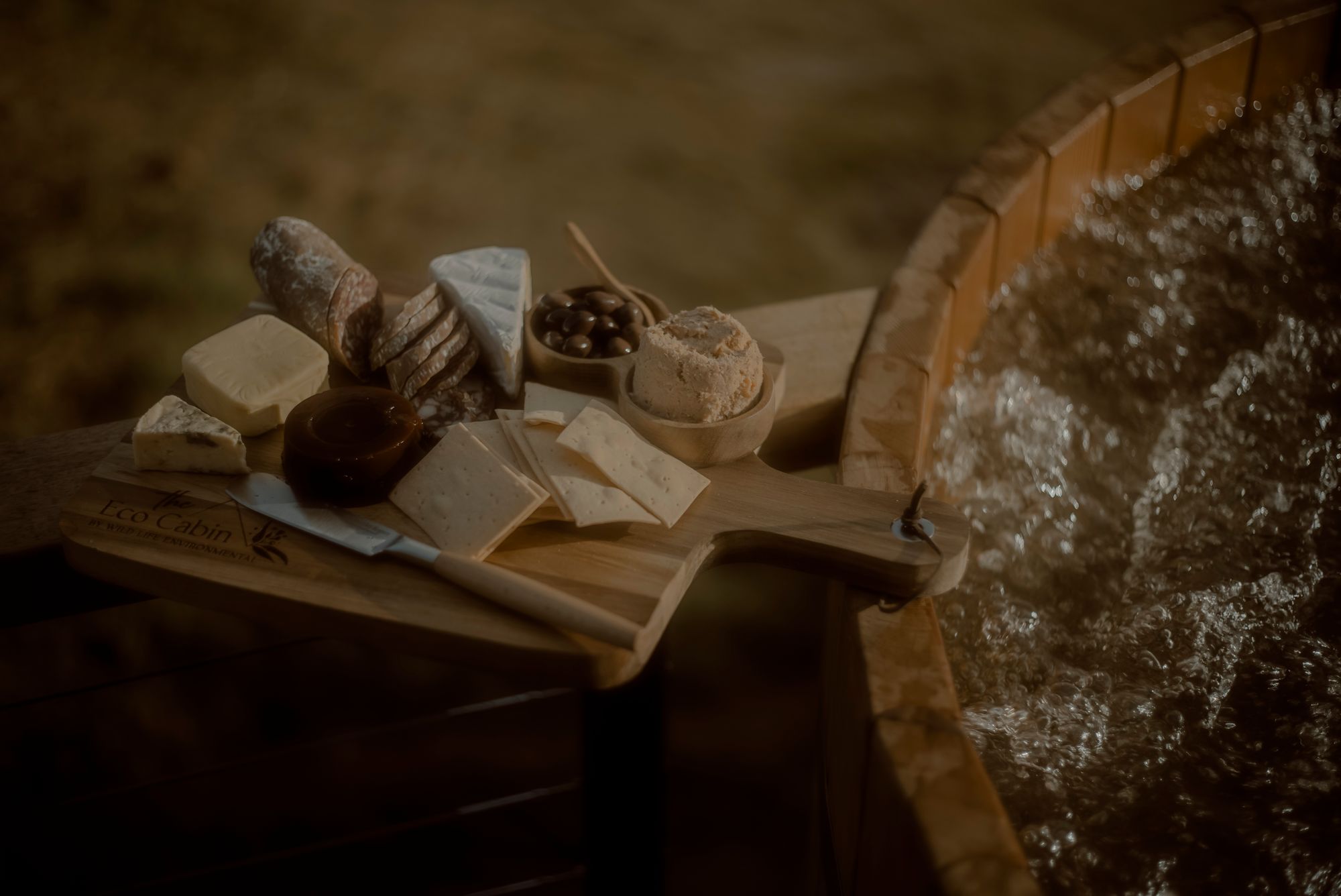 The Eco Cabin Tasmania by Wild Life Environmental. Detailed view of charcuterie board and spa.