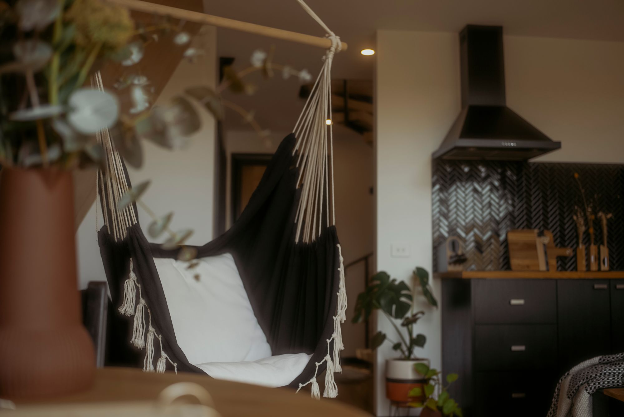 The Eco Cabin Tasmania by Wild Life Environmental. Living room area, image focussed on swing.