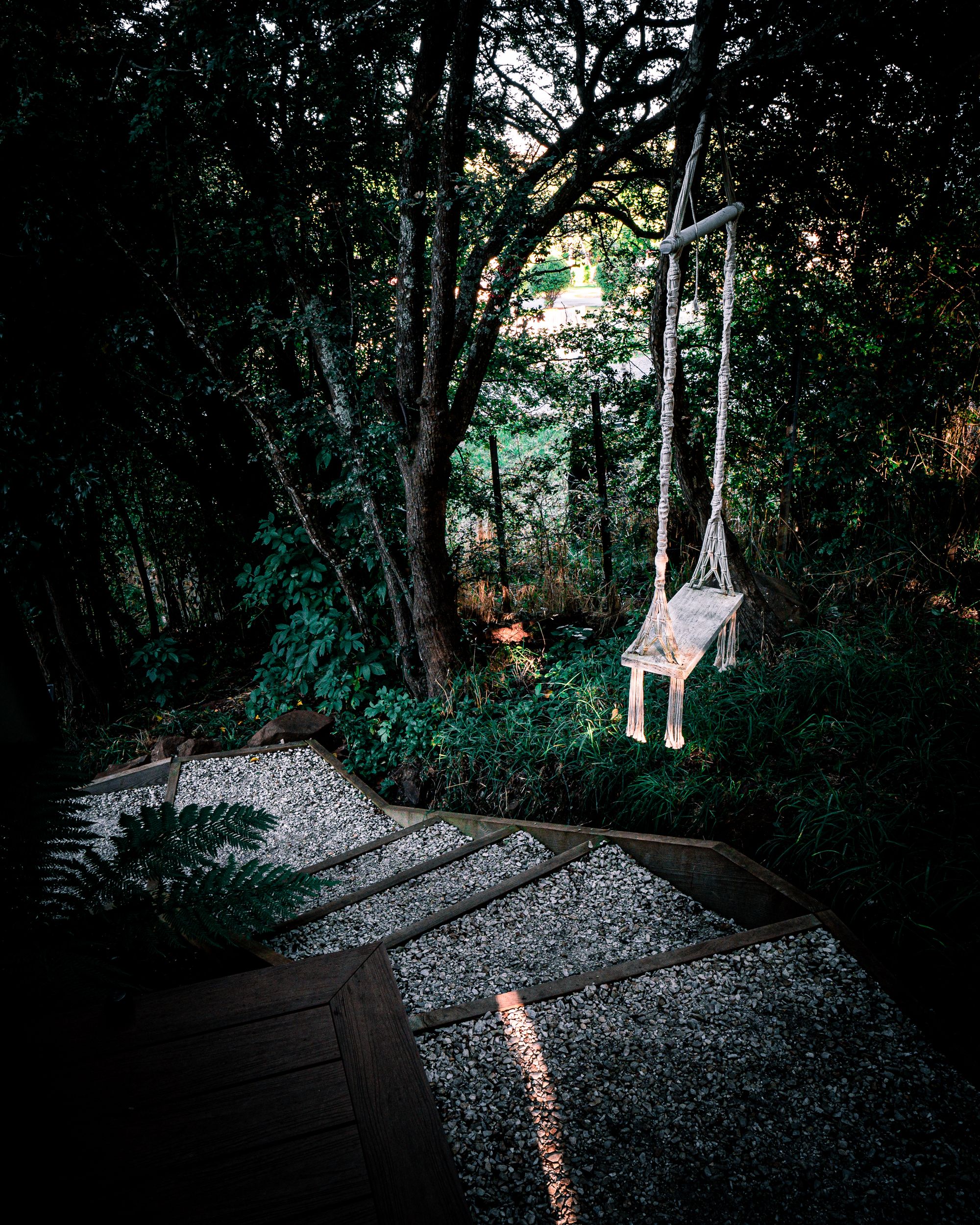 The Eco Cabin Tasmania by Wild Life Environmental. Path down to surrounding bushland, swing positioned to look out at surrounds.