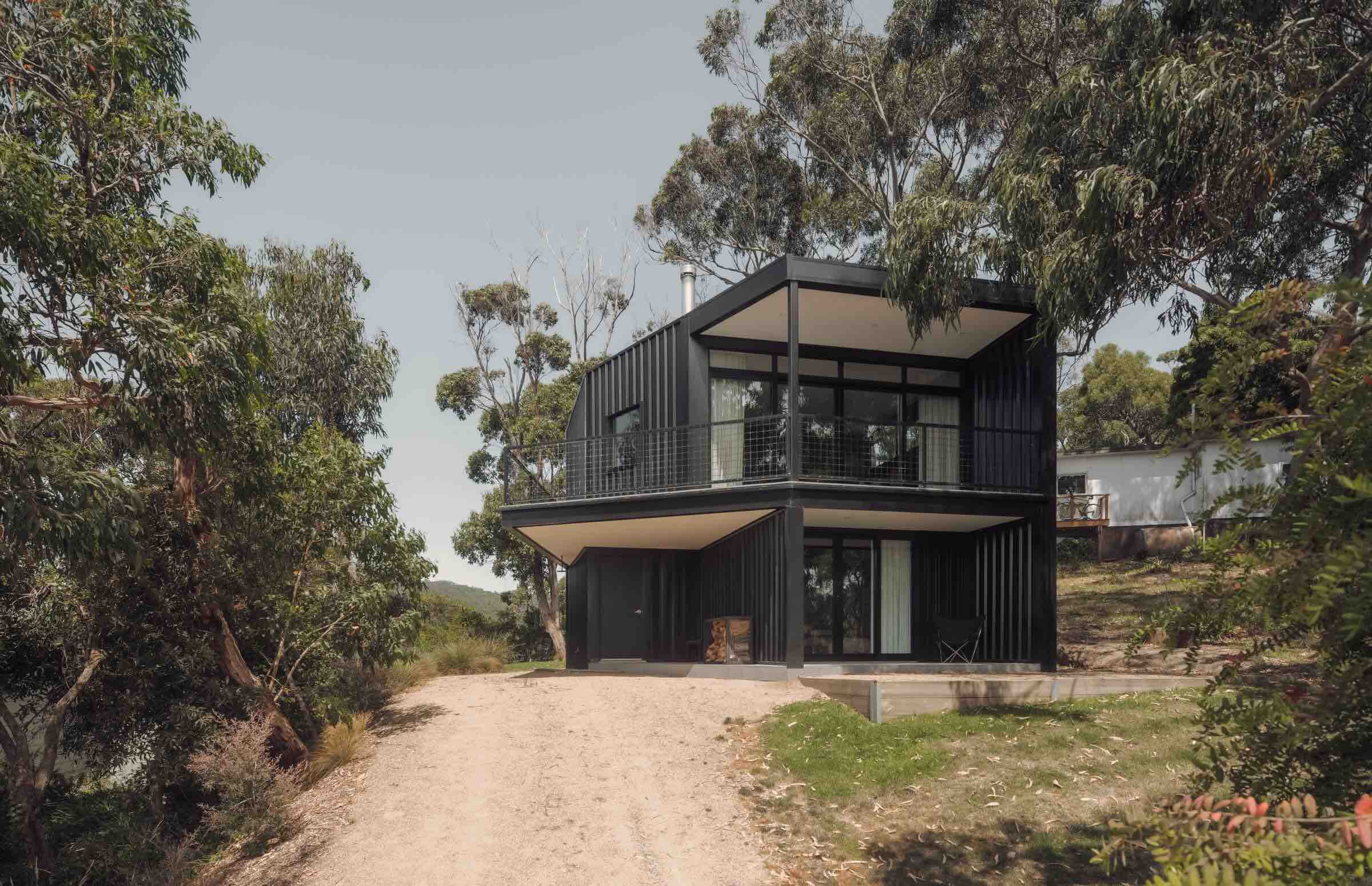Kennett River House by MGAO showing external facade of house and driveway