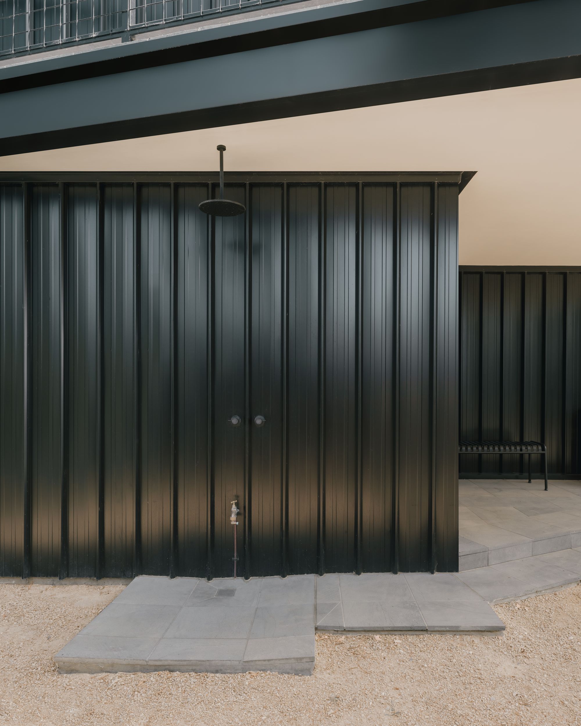 Kennett River House by MGAO showing outdoor shower on metal clad wall