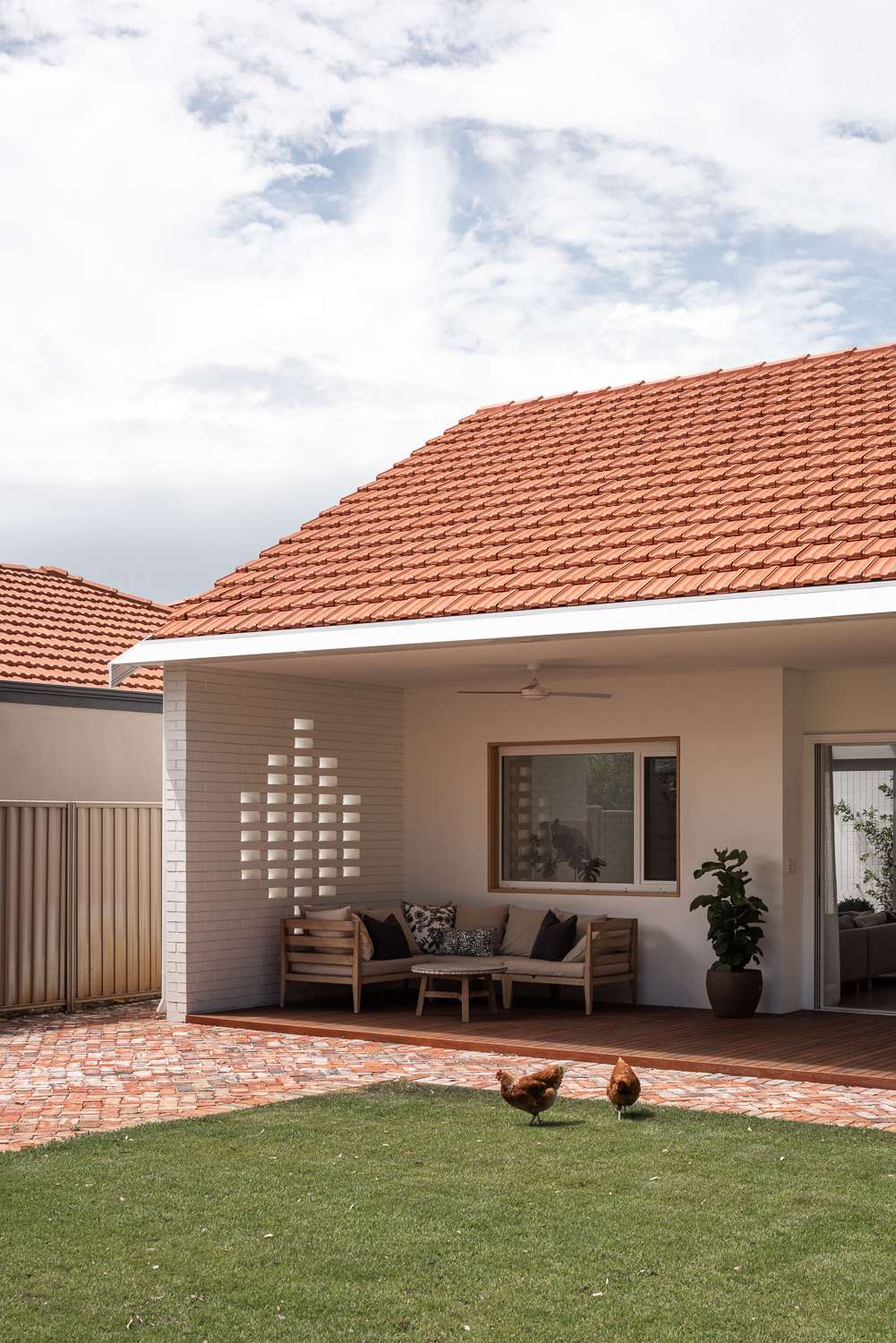 The Third by Dalecki Design showing rear elevation and chicken in the backyard