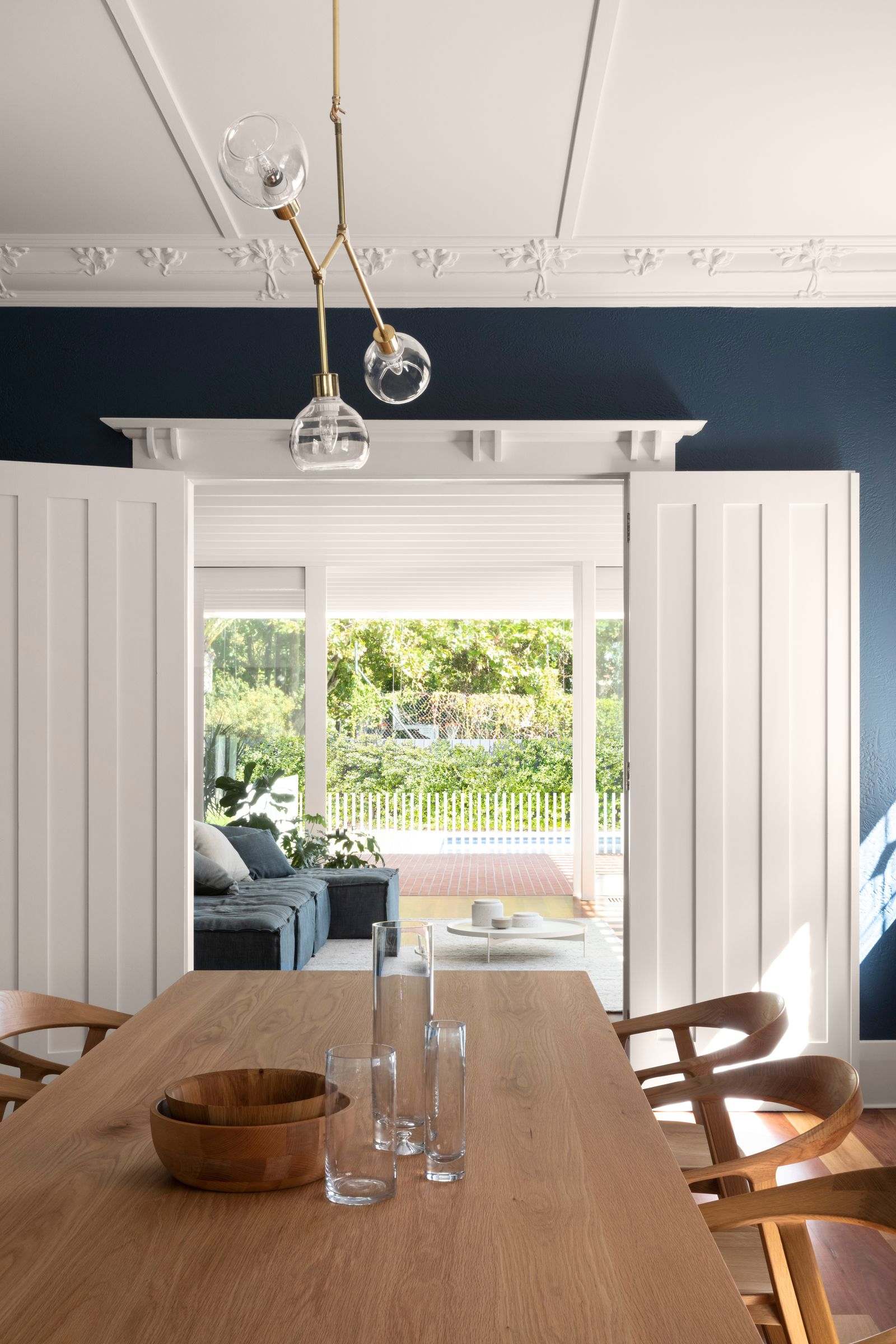 Elwood House by AM Architecture showing refurbished dining room with a dark blue paint colour