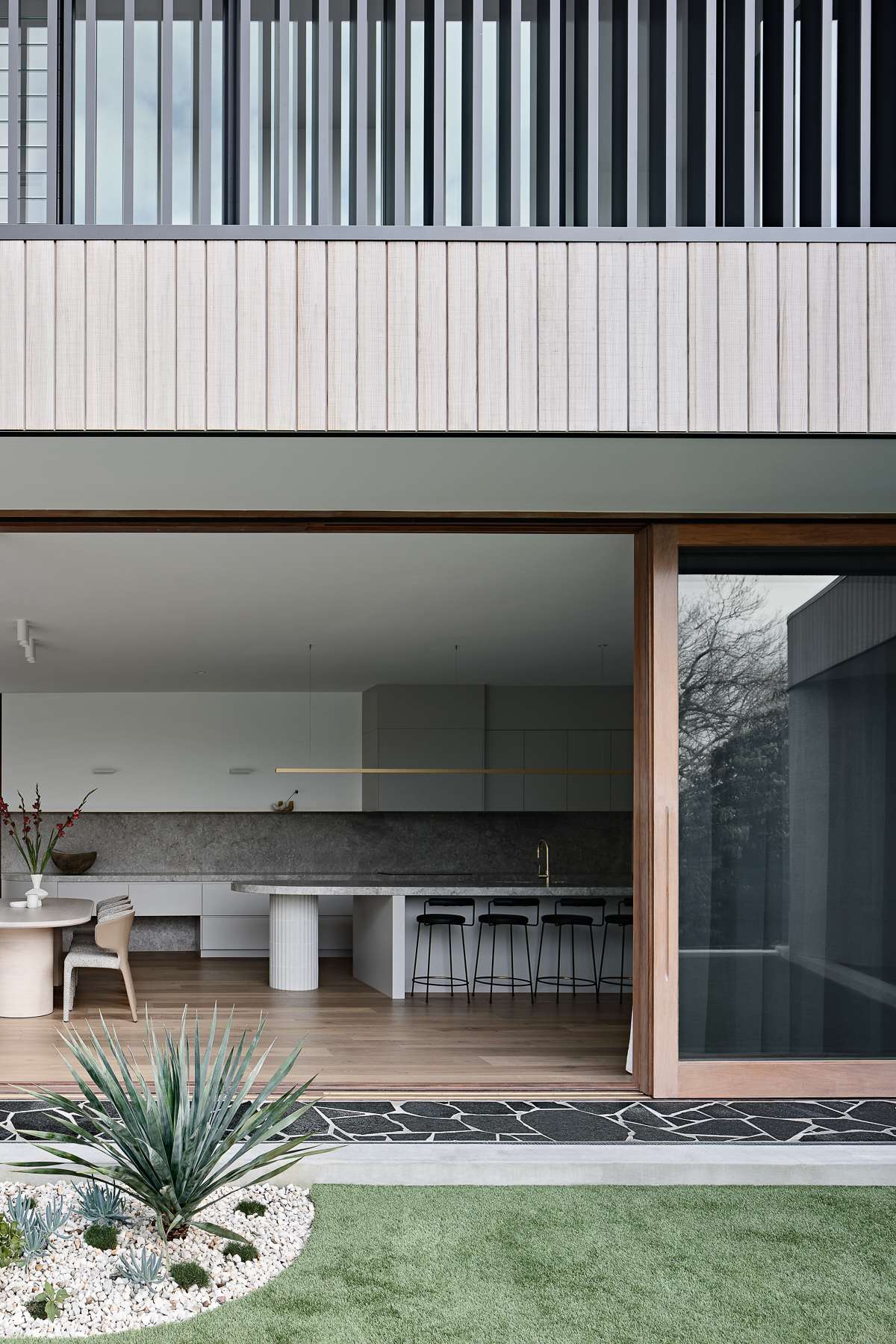 Amiri Courtyard House by Kelder Architects showing large timber doors open
