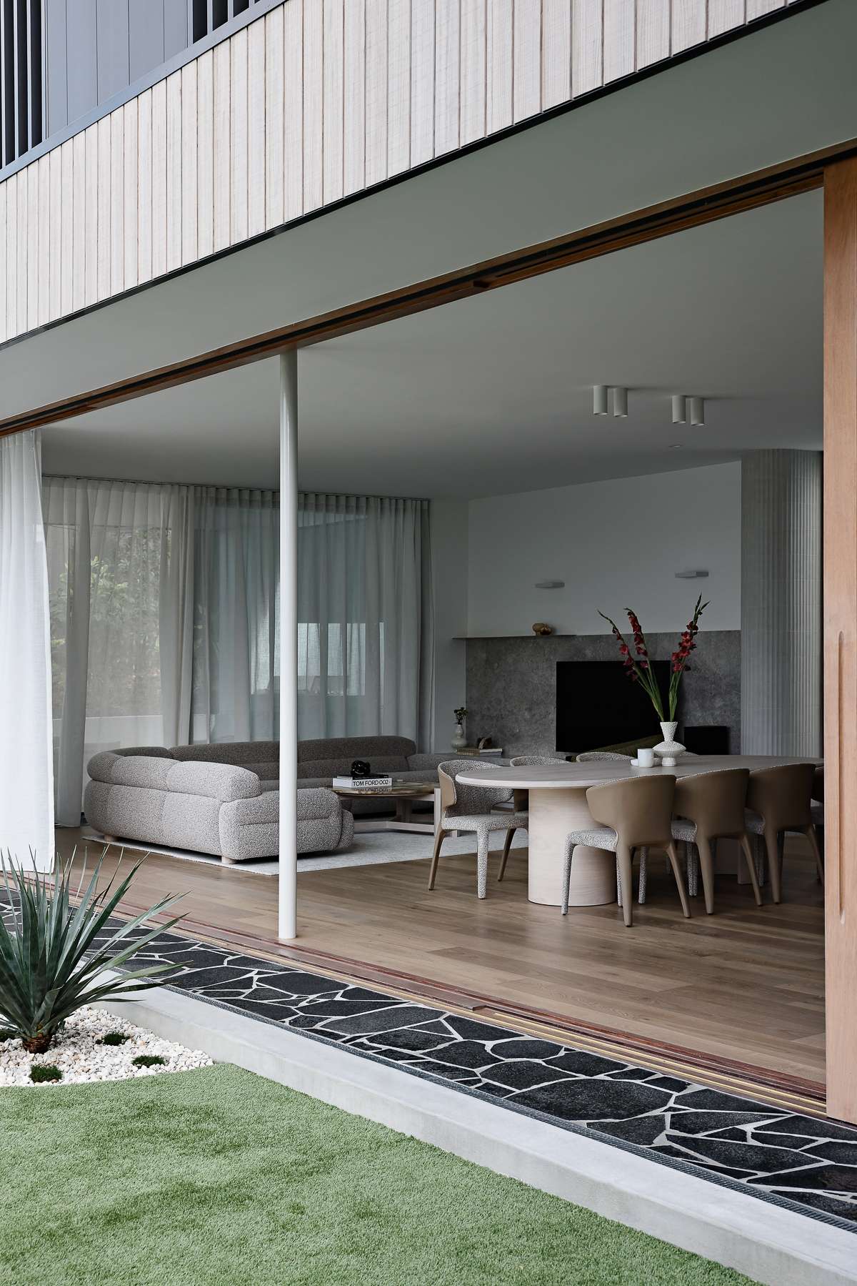 Amiri Courtyard House by Kelder Architects showing dining and living areas from the outside