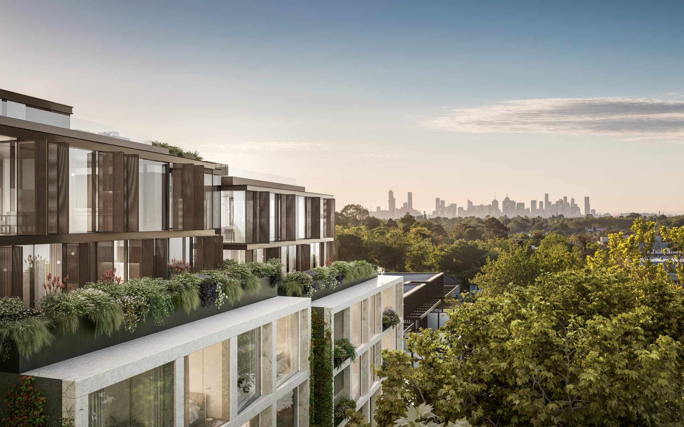 Arbour Park, Surrey Hills by Prime Edition.A modern residential building facade with a panoramic view of a distant city skyline. The building features a series of balconies with glass balustrades and green planting, integrating natural elements into the urban environment. The design is sleek and contemporary, with clear skies above and lush treetops in the foreground.