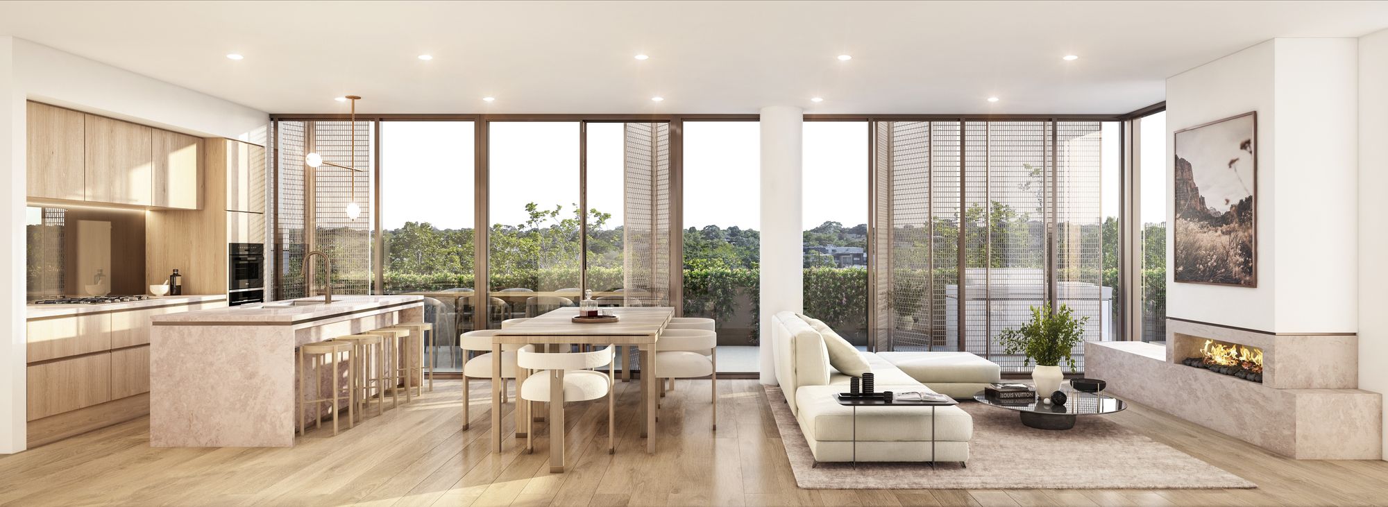 Arbour Park, Surrey Hills by Prime Edition.An open-plan kitchen and dining area with a modern aesthetic. The kitchen features a large island with seating for four and high-end appliances. The dining area includes a simple yet elegant wooden table with matching chairs. The space is well-lit by natural light from floor-to-ceiling windows that also provide a view of the balcony and greenery outside.