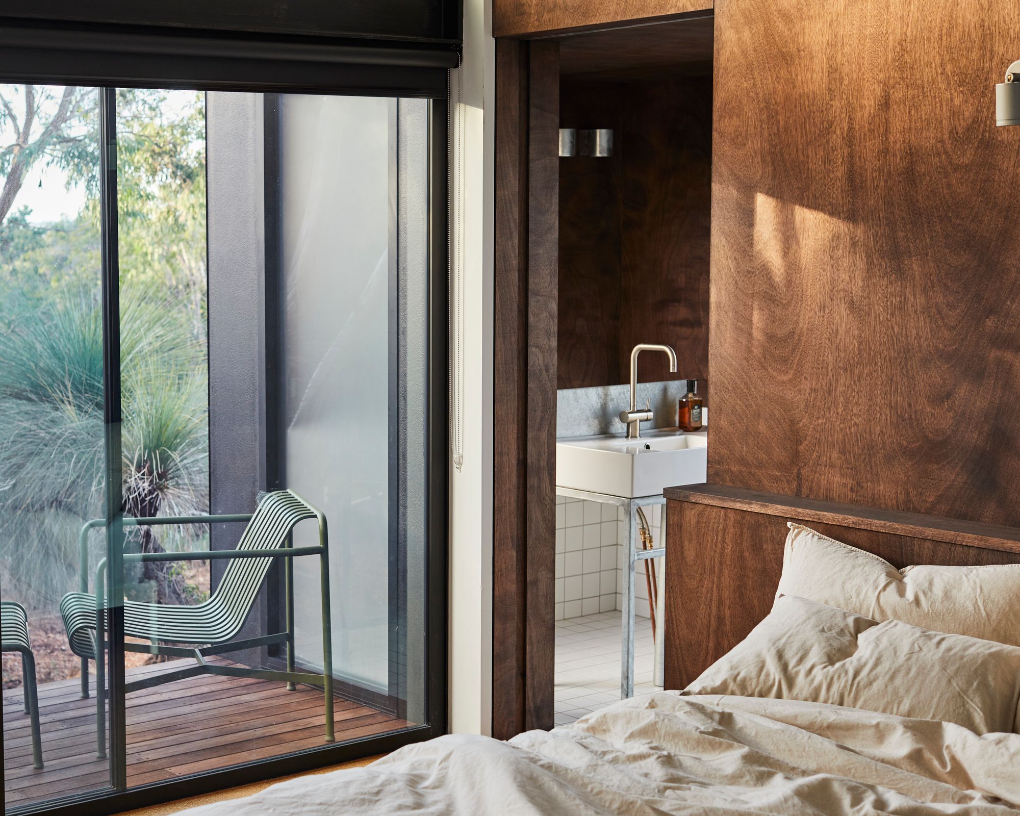 An interior view of the bedroom and ensuite at DEN PLACE