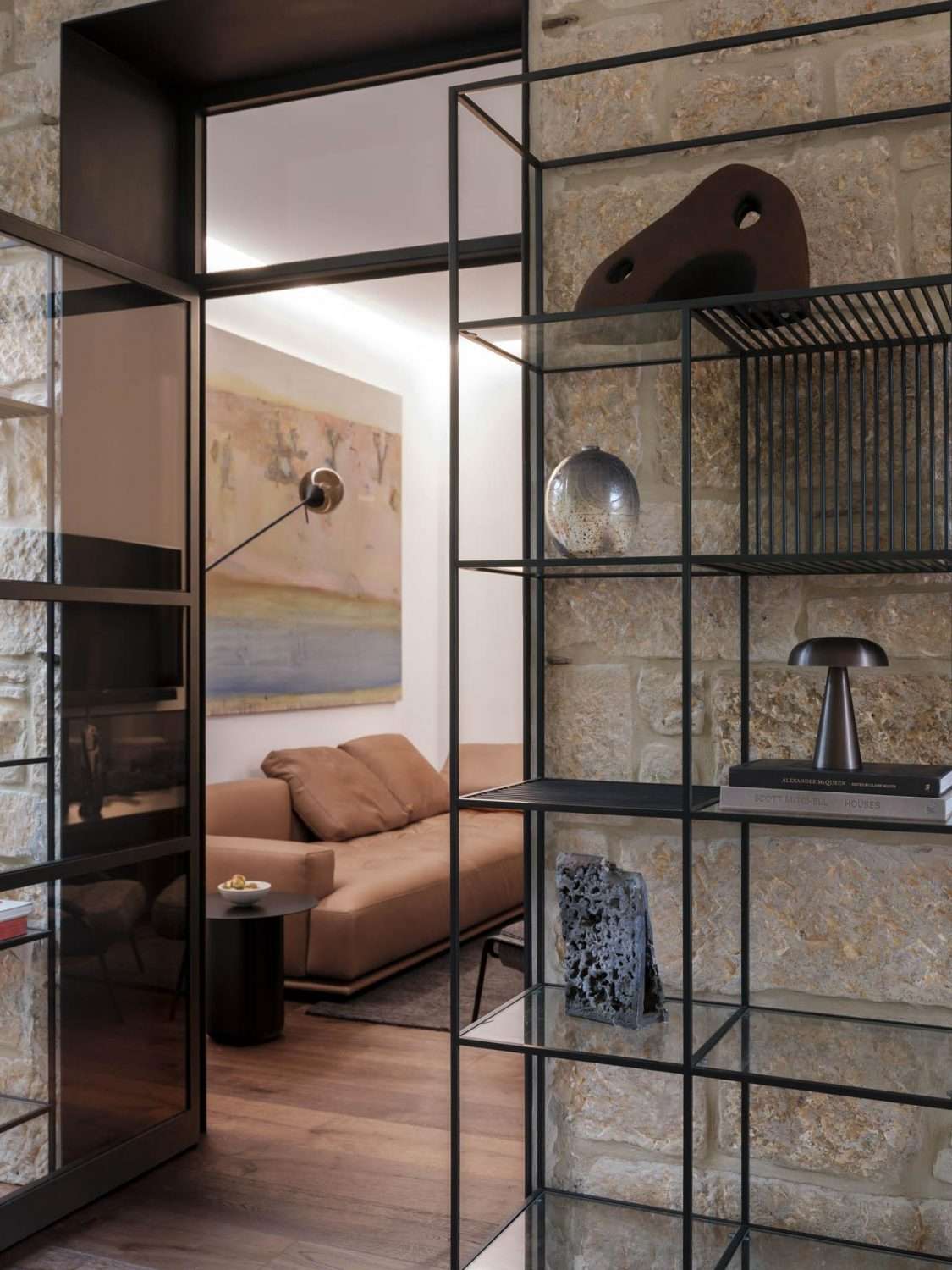 Maranatha House by BIJL Architecture showing an interior shot of open shelving and a glimpse into the living room