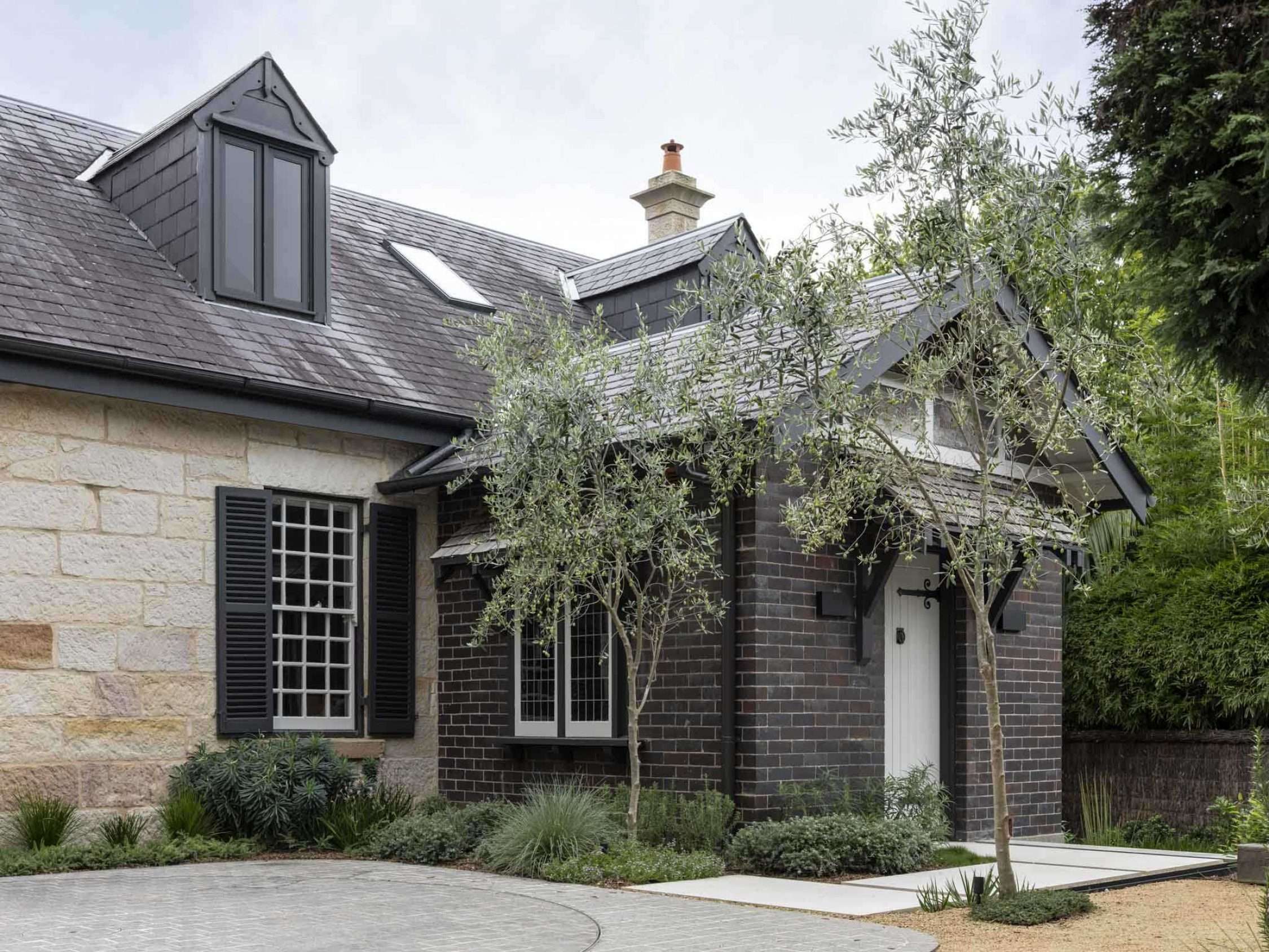 Maranatha House by BIJL Architecture showing the heritage front entry with sandstone and brickwork