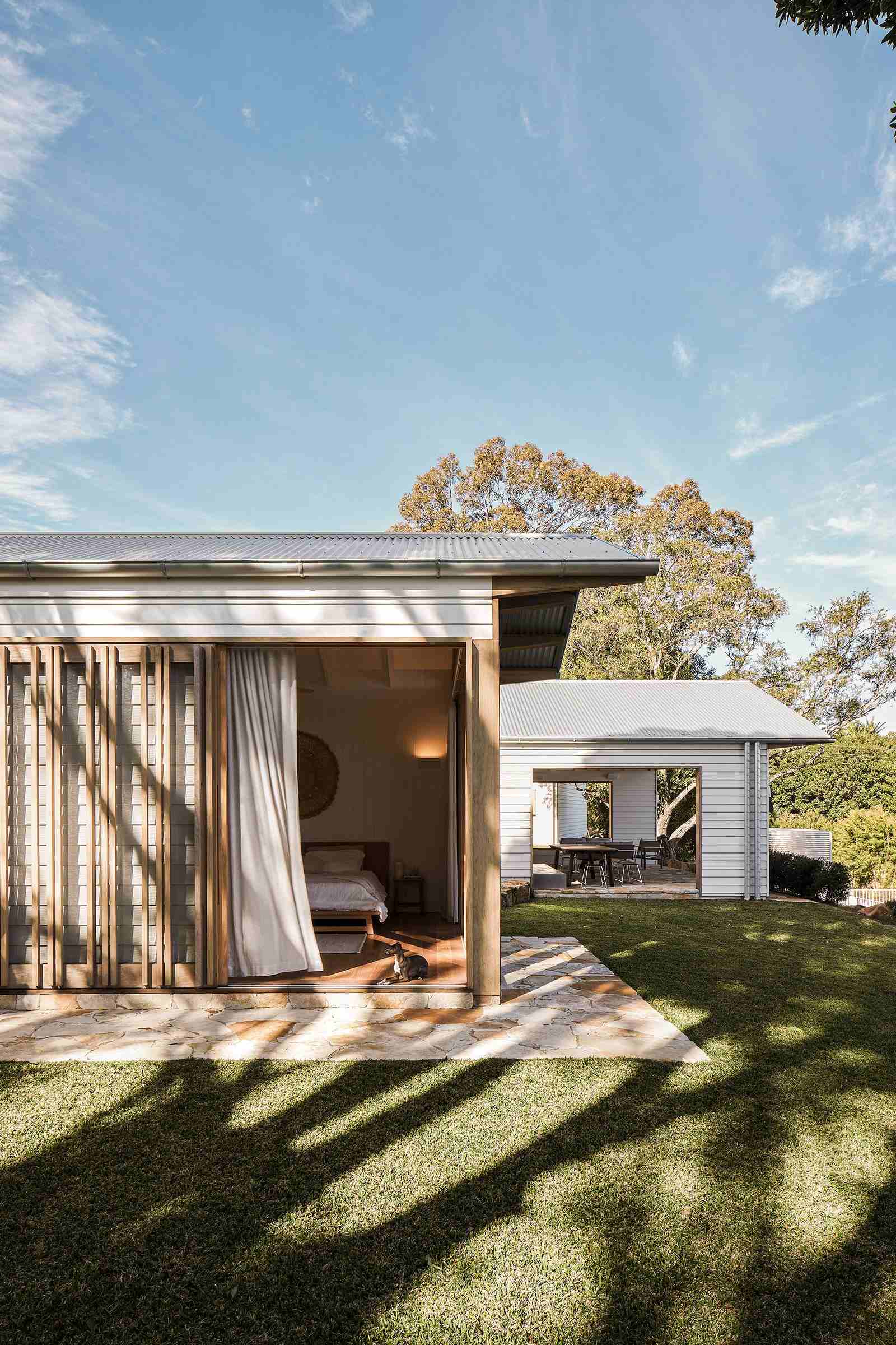 The Caretaker's by Aphora Architecture showing the new building with the existing in the background