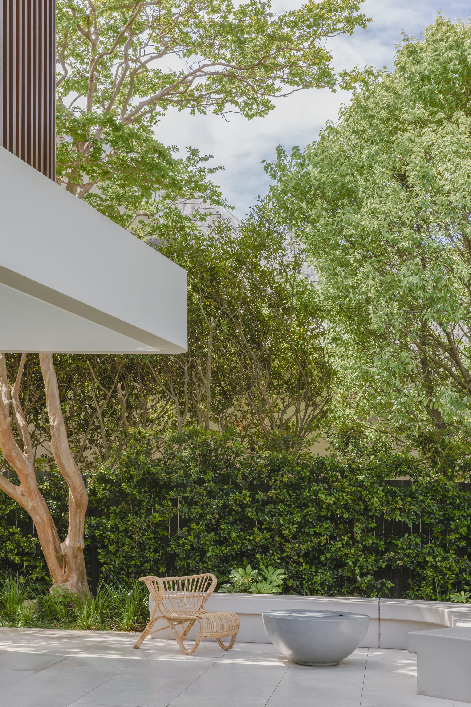 Kenneth Street by Design Studio Group showing an outdoor seating area in the garden