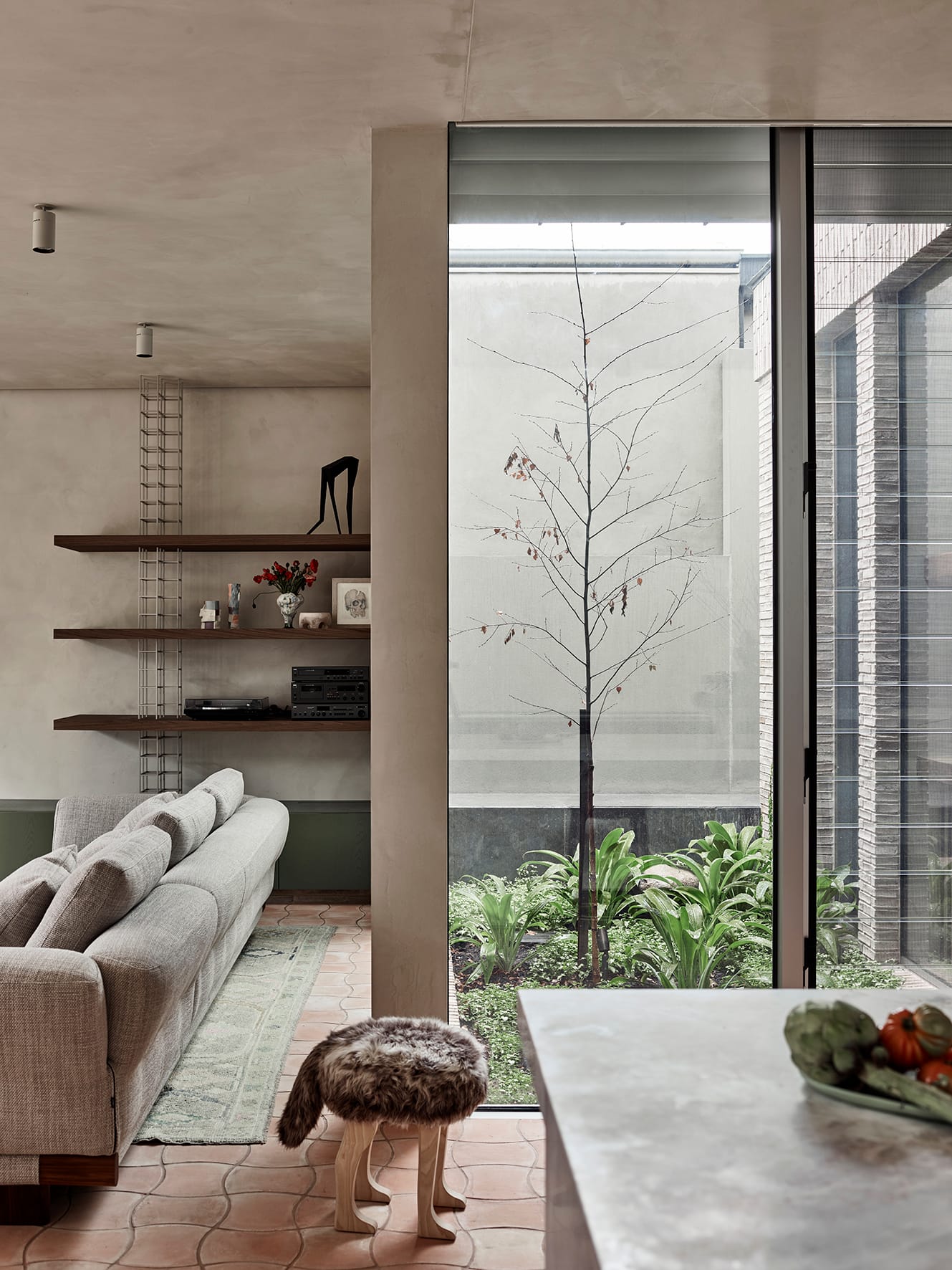 Terra Firma by RobsonRak. Photography by Mark Roper showing the inner garden courtyard with views from the kitchen