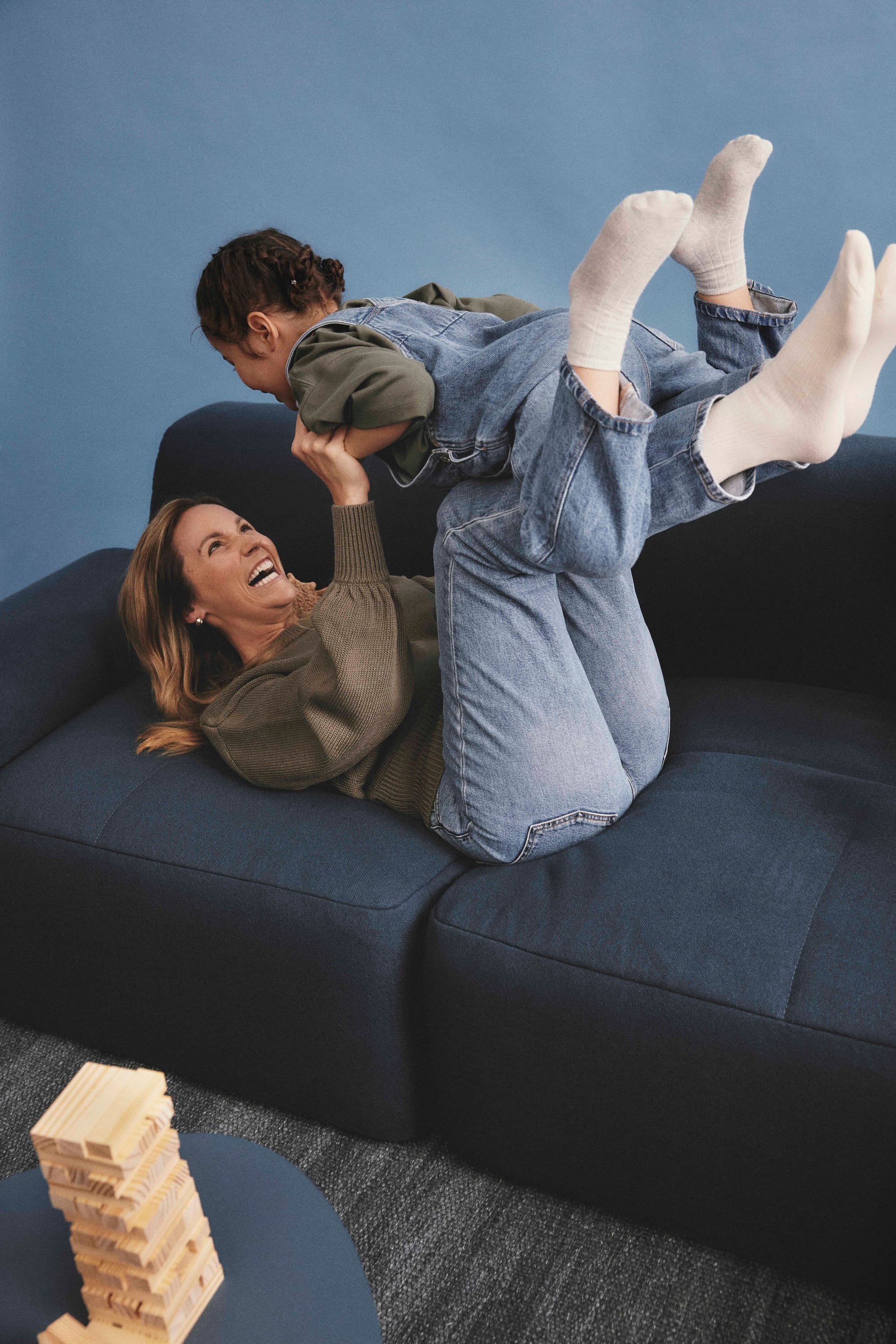 Eva Everyday Sofa. Copyright of Eva. Woman playing with child on the atlantic modular lounge. 