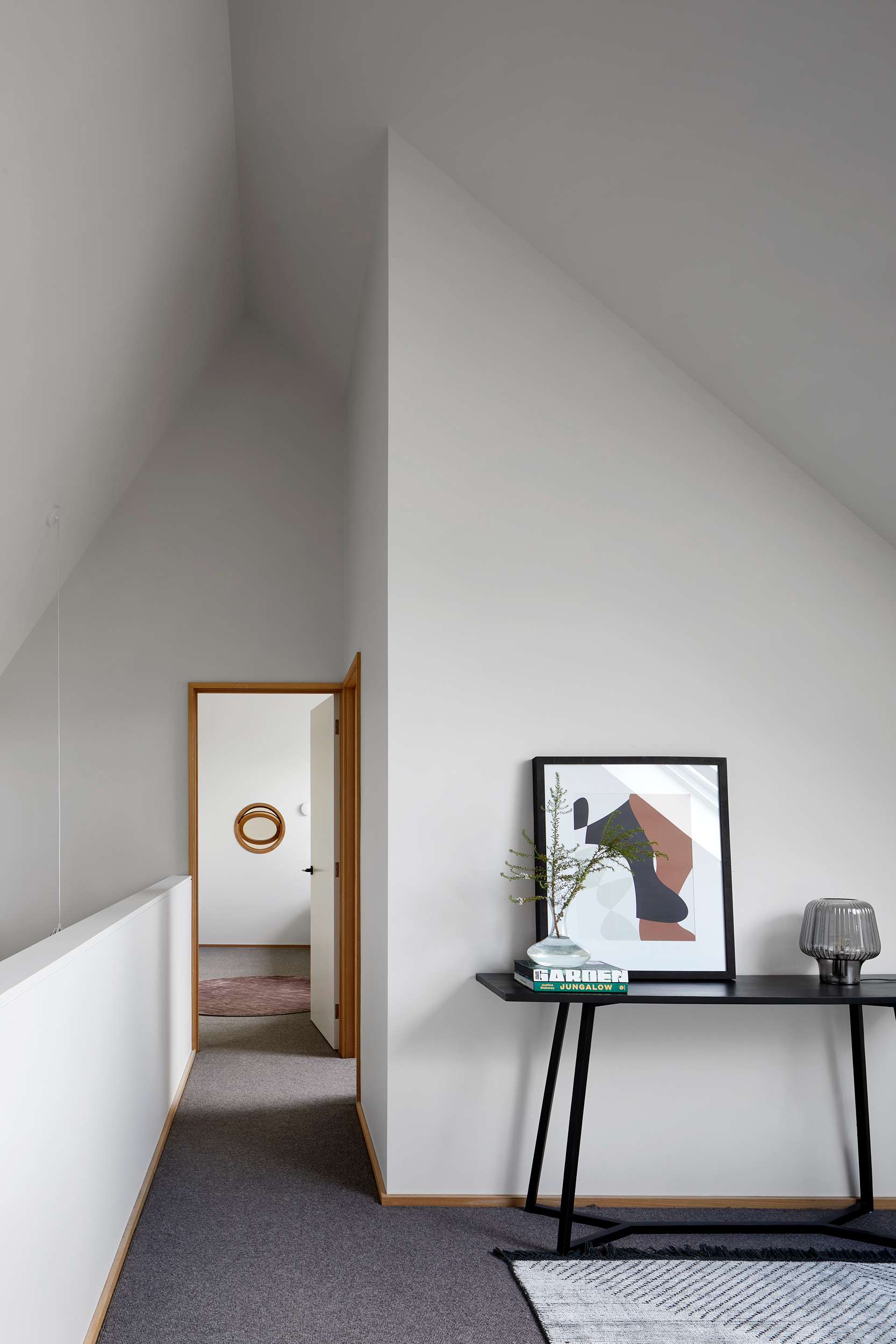 An interior view of the loft space with white plasterboard walls and high ceilings