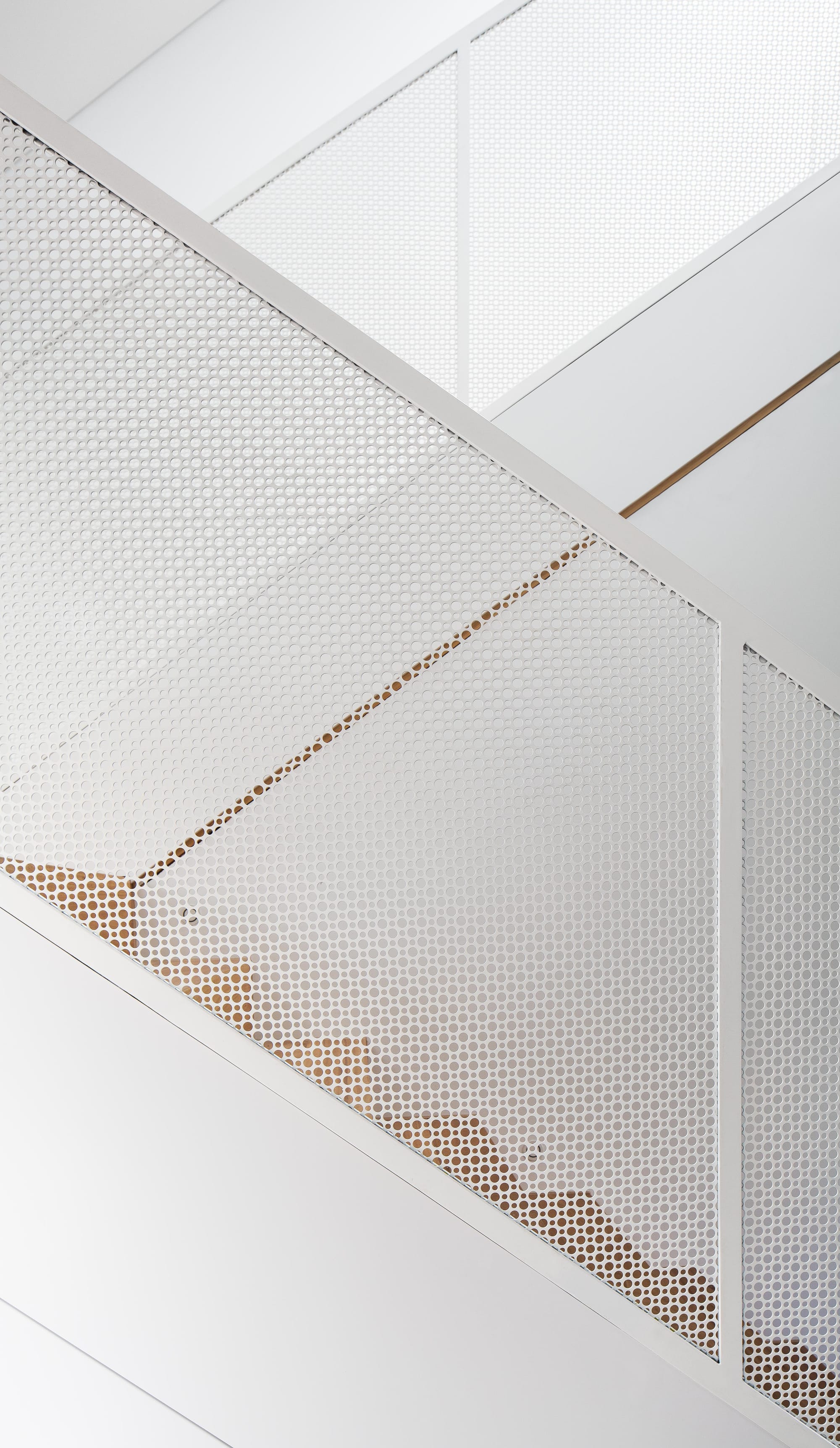 A detail shot of the white metal balustrade on the internal staircase