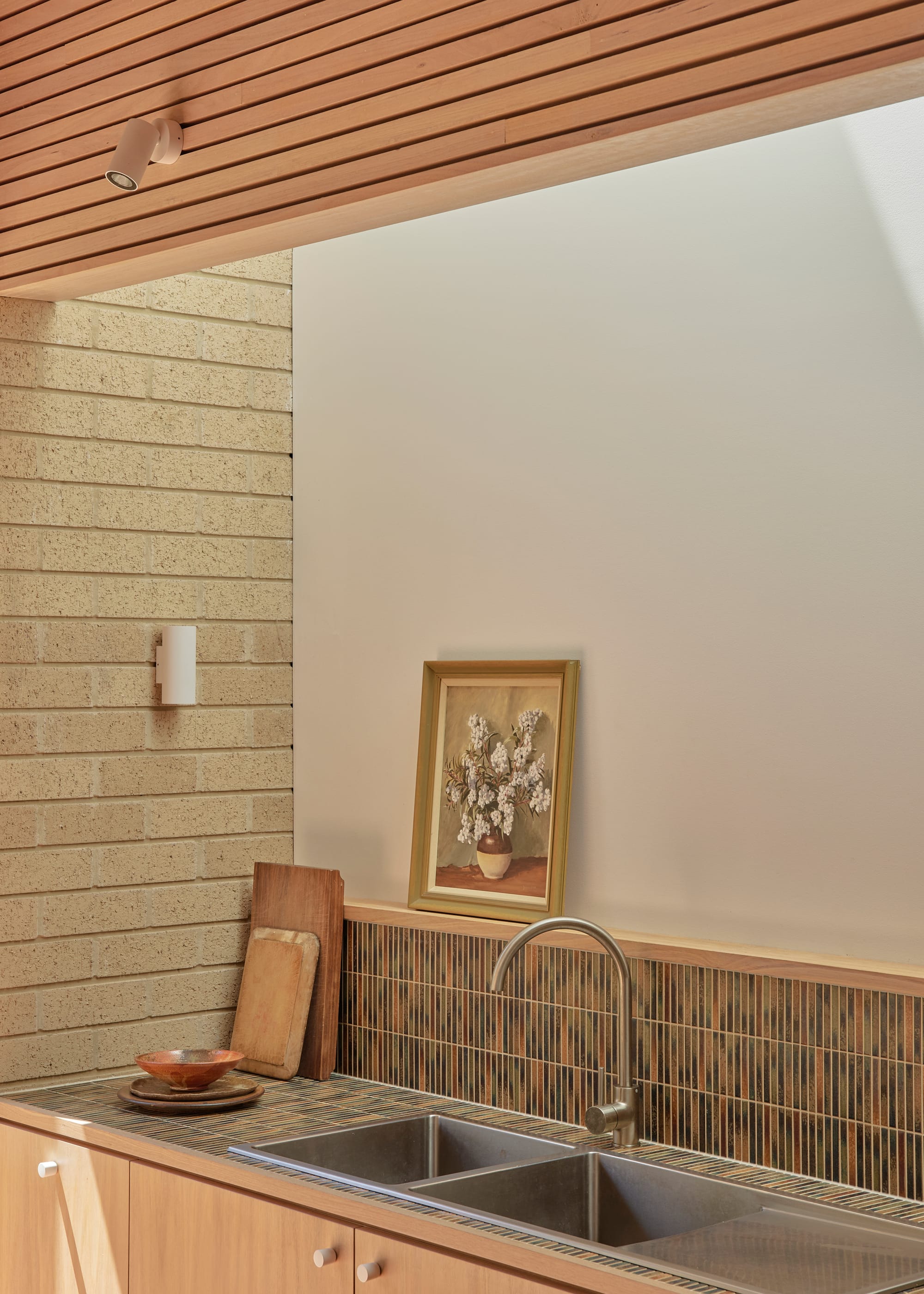 Harriet's House by SO:Architecture. Photography by Sean Fennessy. Kitchen with tiled counter and splashback. Brick wall to the right. Tasmanian Oak counters.