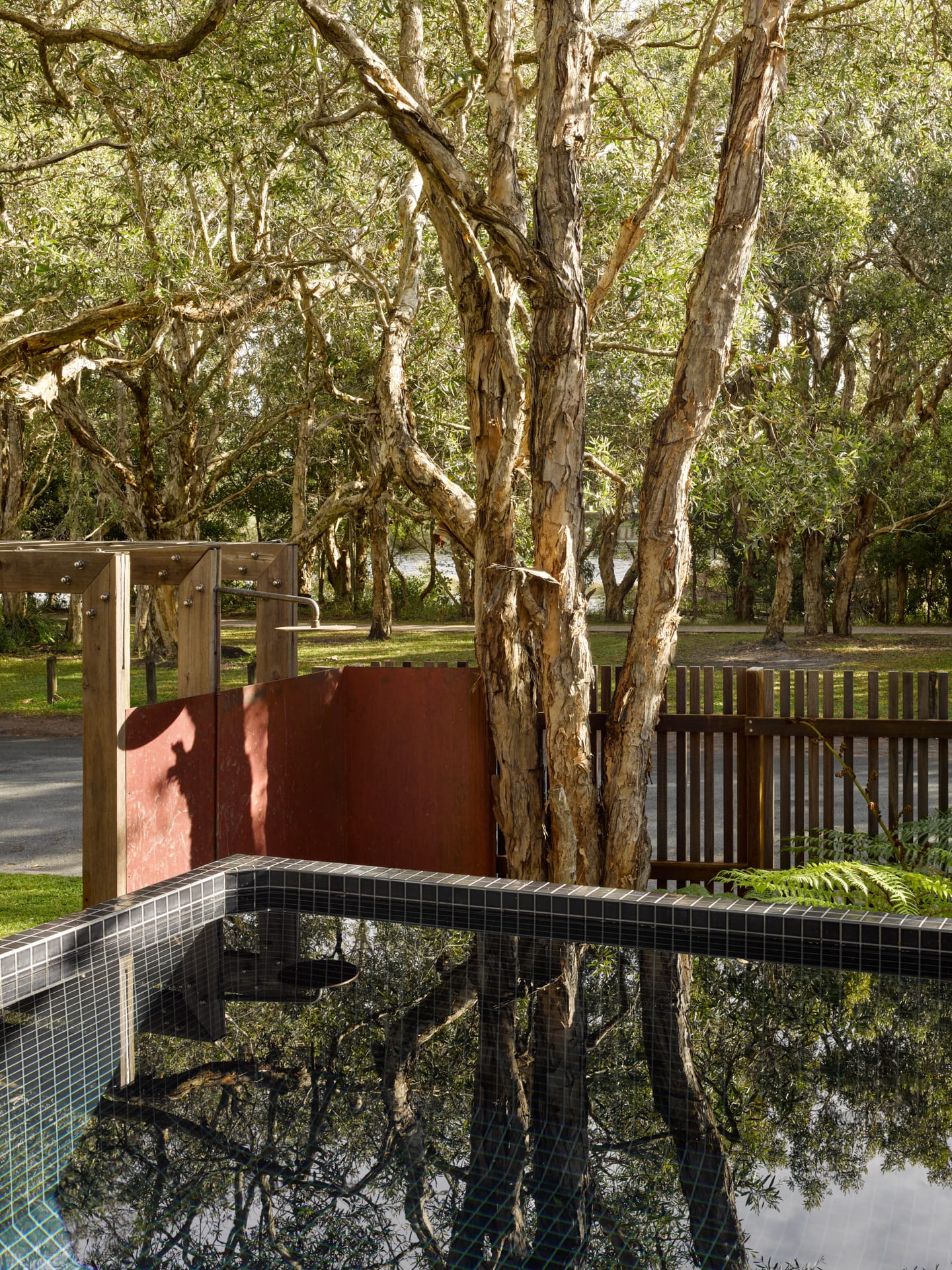 PaperBark Pod by Bark Design. Photography by Christopher Frederick Jones. Tiled plunge pool overlooking riverfront in the background. Native trees growing.