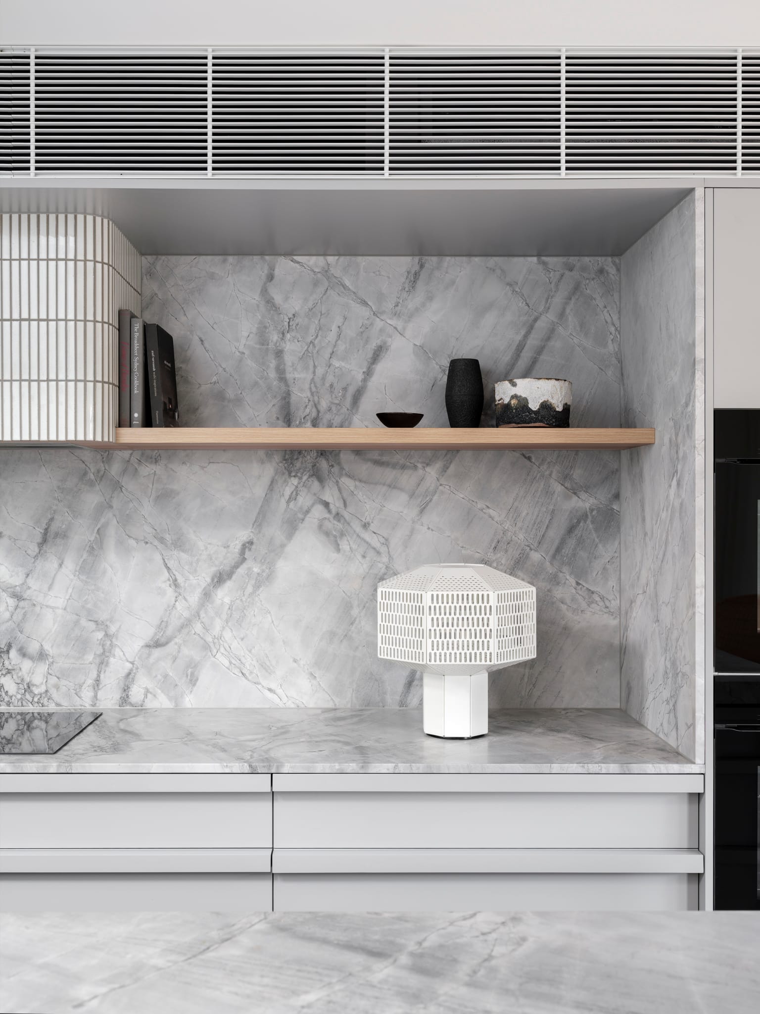 Bellevue House by Carla Middleton Architects. Photography by Tom Ferguson. Marble benchtop and splashback. Floating timber shelving. Geometric white lamp. 