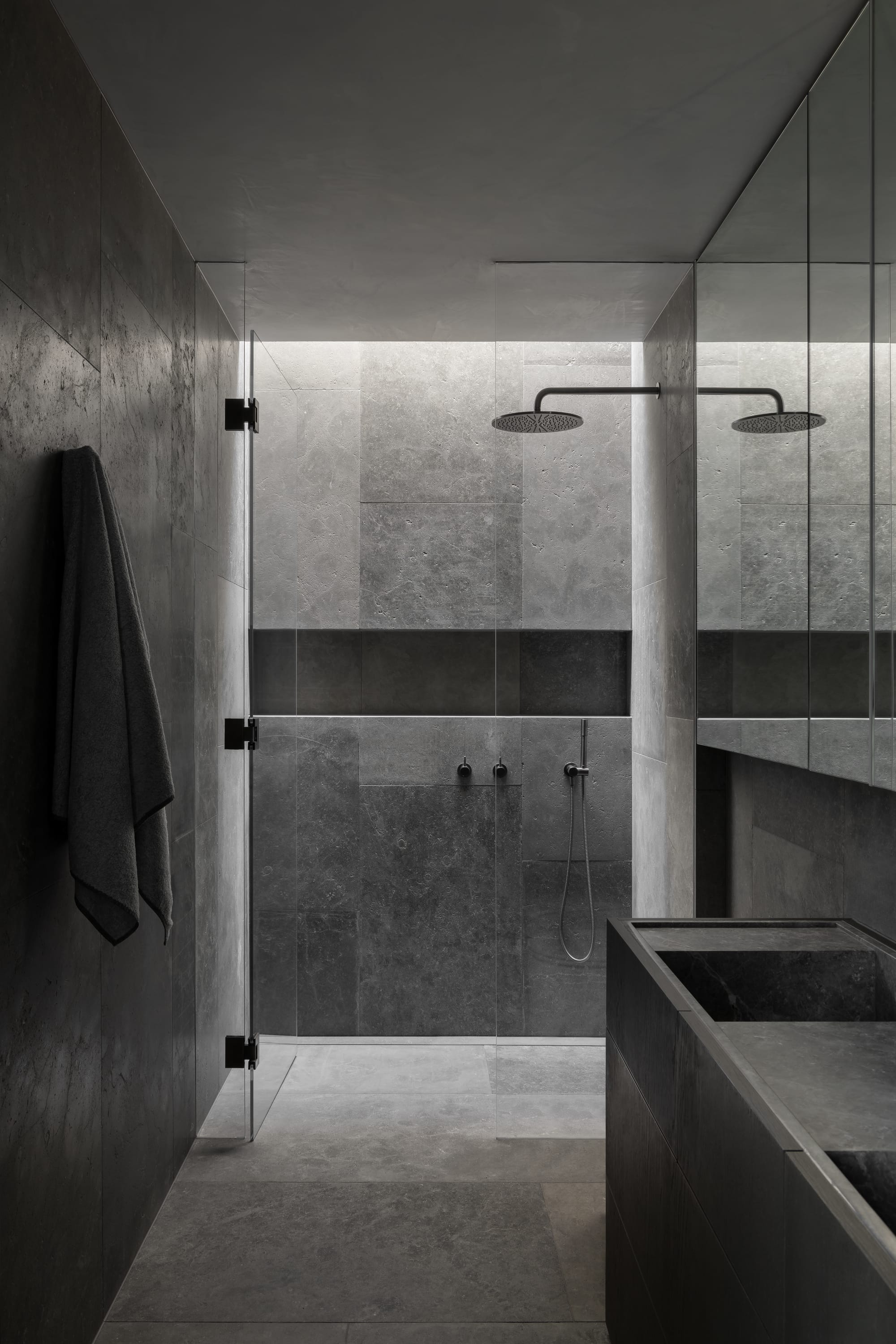 Cliff House by Finnis Architects. Photography by Timothy Kaye. Bathroom with stone floors, walls and countertops. Integrated double sinks and shower shelf.