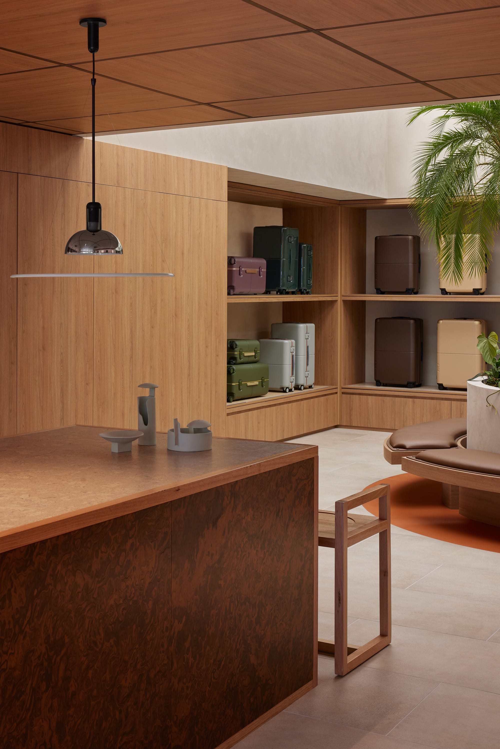 An interior shot of the July store showing an island bench and a glimpse of the seated planter