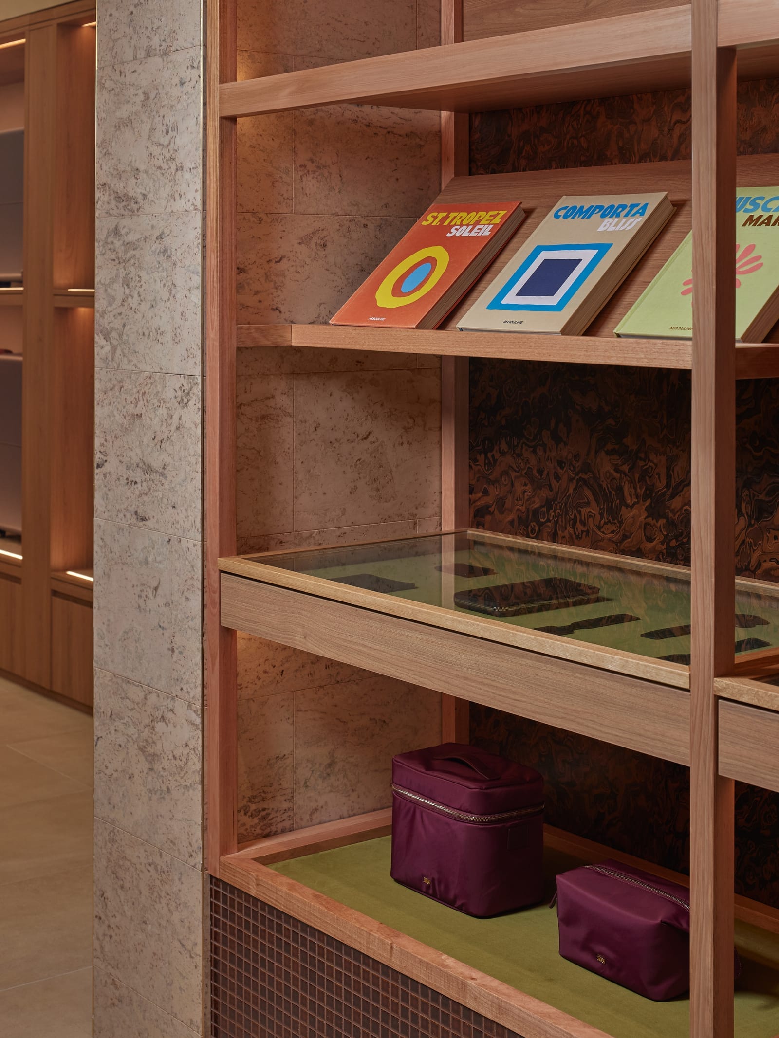 July Store by Acre. Photography by Cieran Murphy. Close up of timber shelving. Stone tiled wall. Green felt on display shelves. 