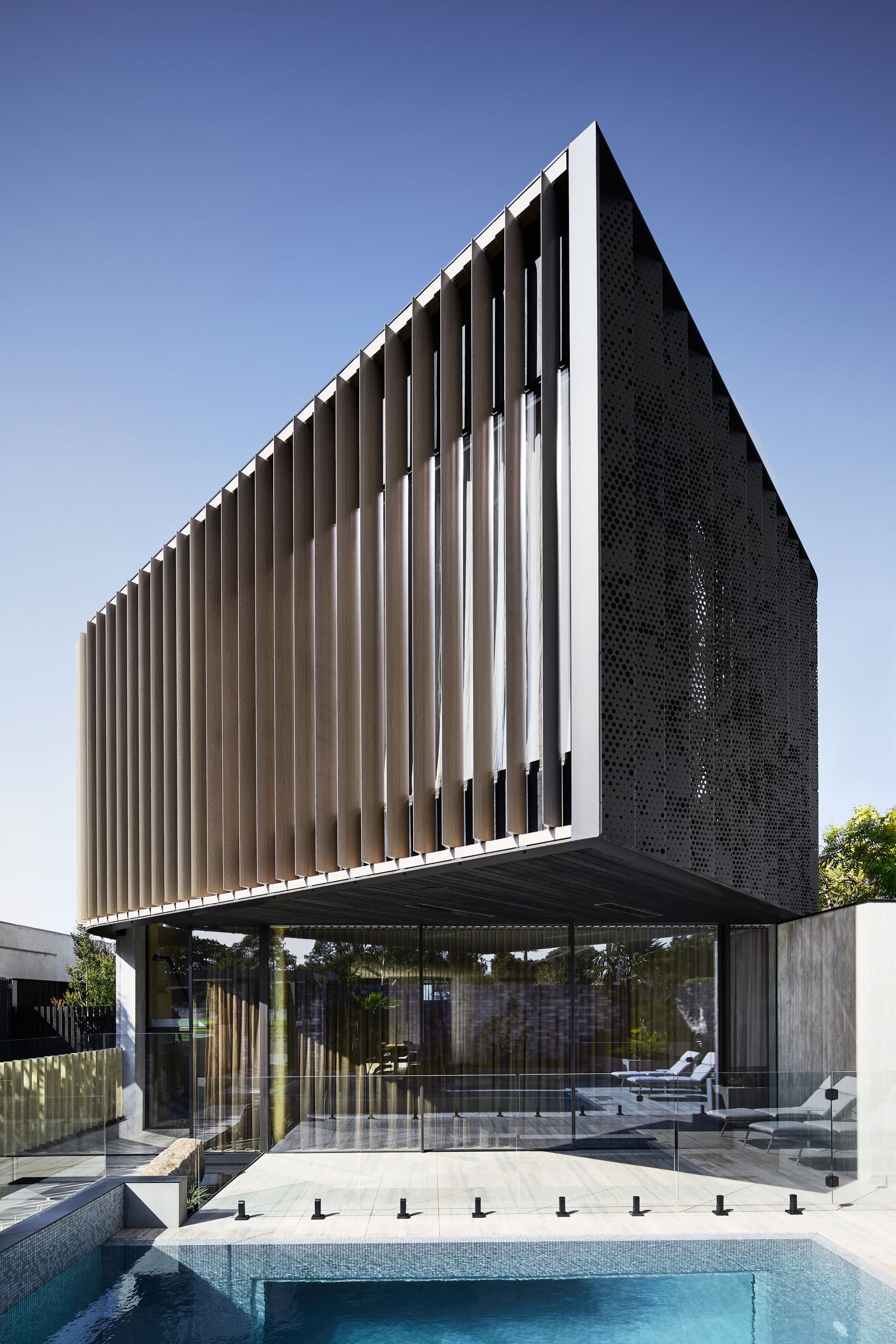 The Split Home by Seidler Group. Copyright of Seidler Group. Pool and courtyard at residential home. Contemporary, double storey home with metal encased second floor. 