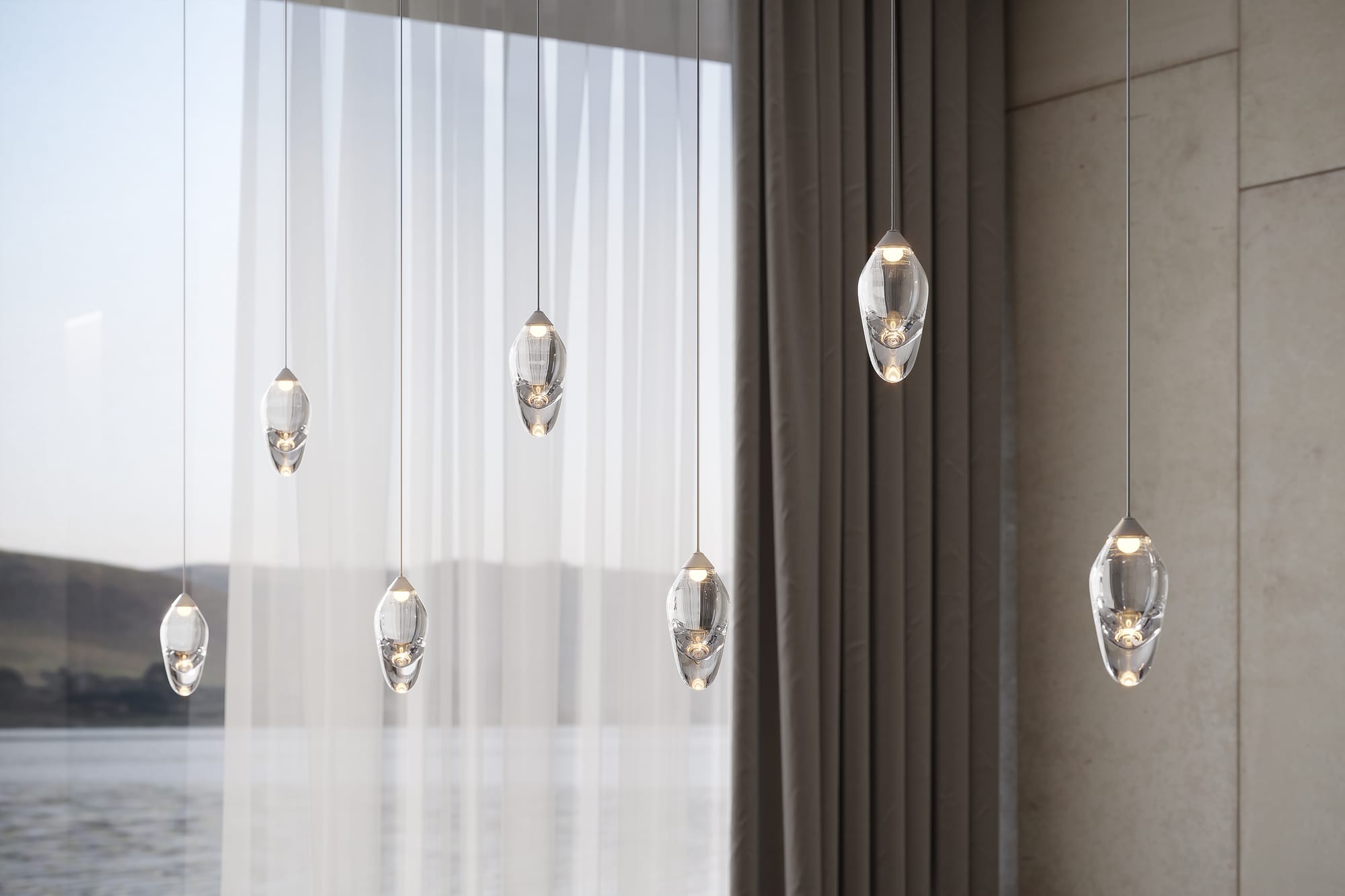 OST Pendant Light by SOKTAS. Copyright of SOKTAS. Teardrop individual pendants hung in cluster. Window in background overlooks lake. 