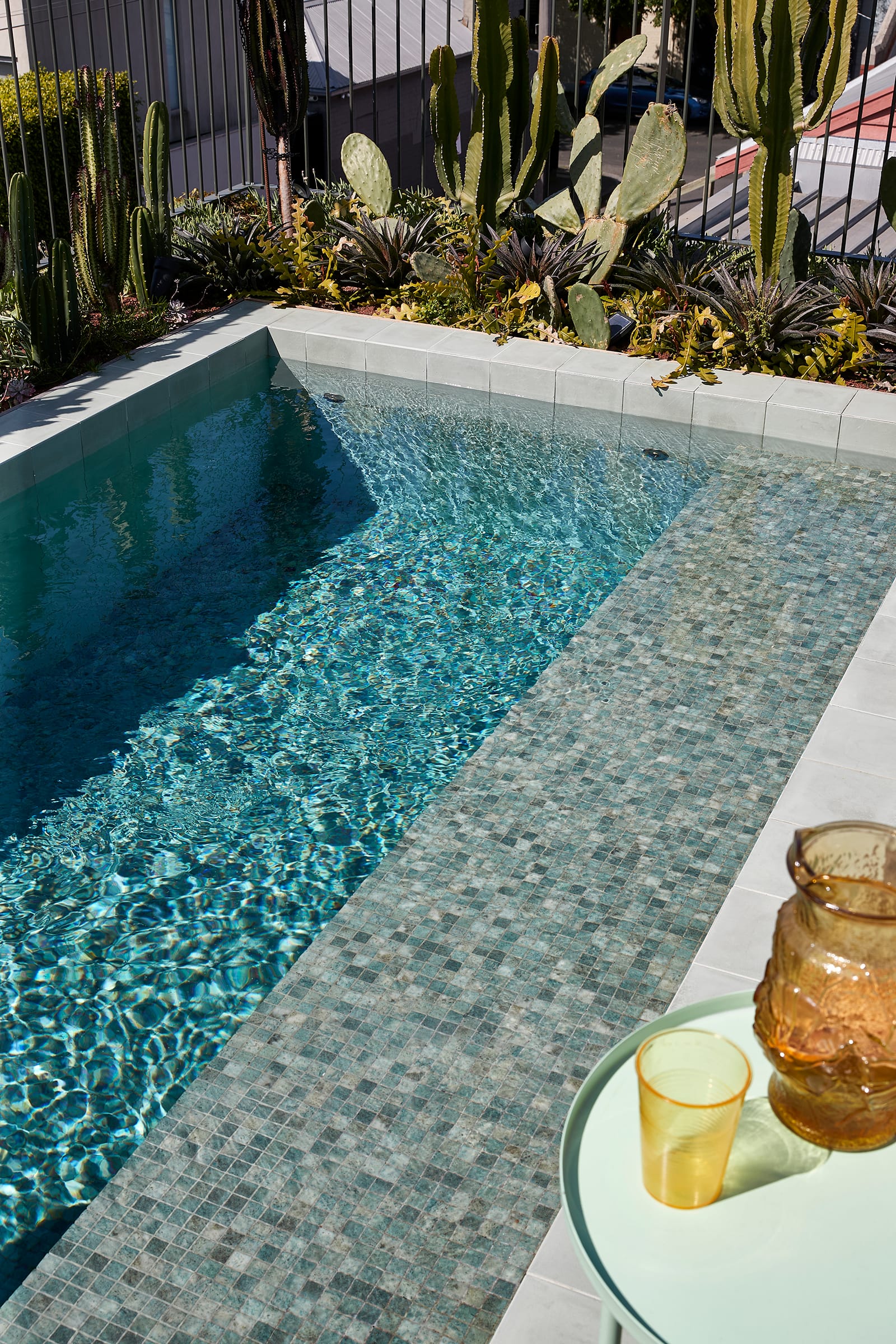 Fabrica by mcmahon and nerlich. Photography by Shannon McGrath. Mosaic tiles pool with succulent garden around. Concrete brick edge.